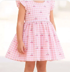 young girl wearing a lavender dress and hat