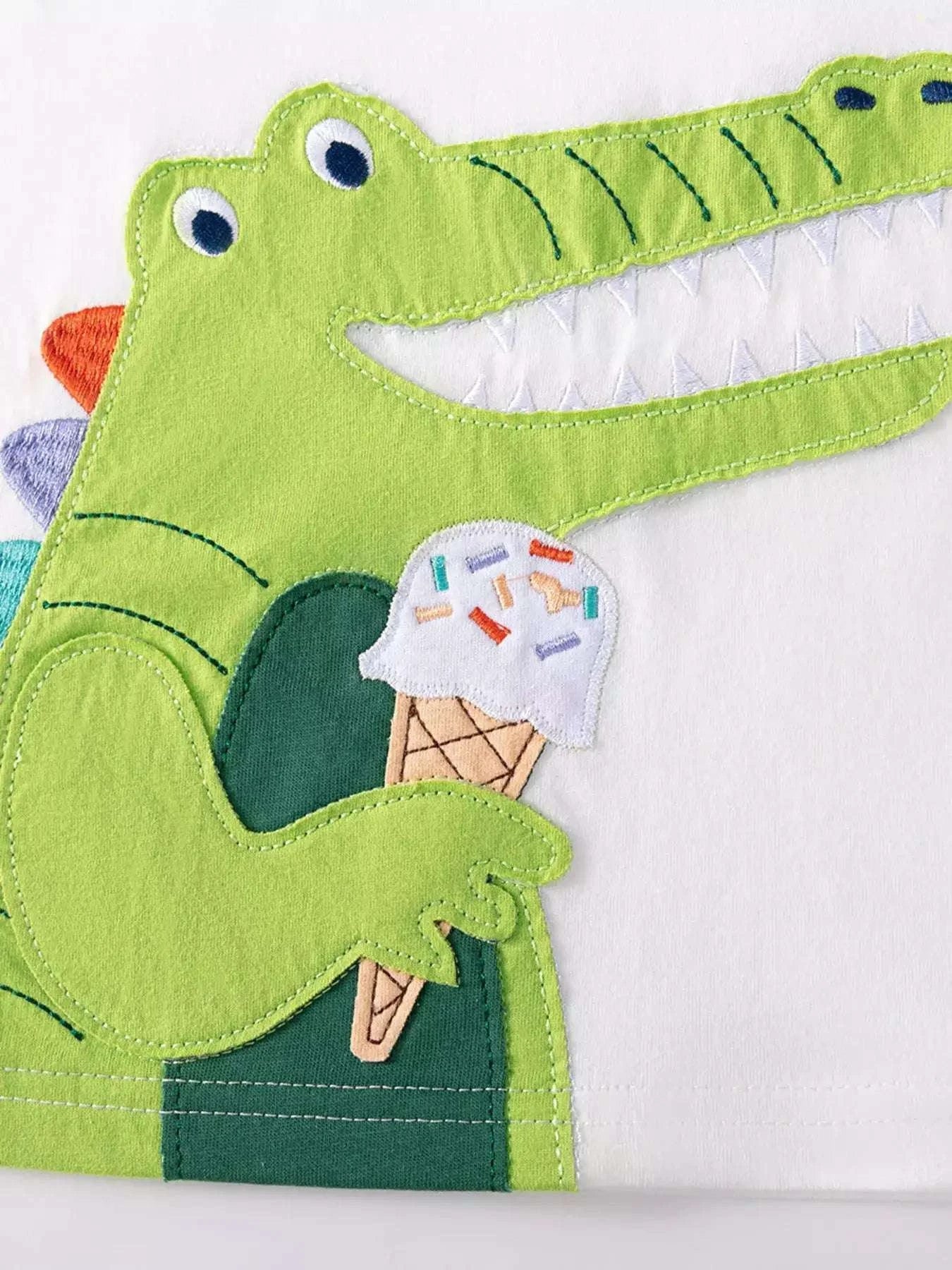 Children's crocodile graphic tee with ice cream cone embroidery on white fabric