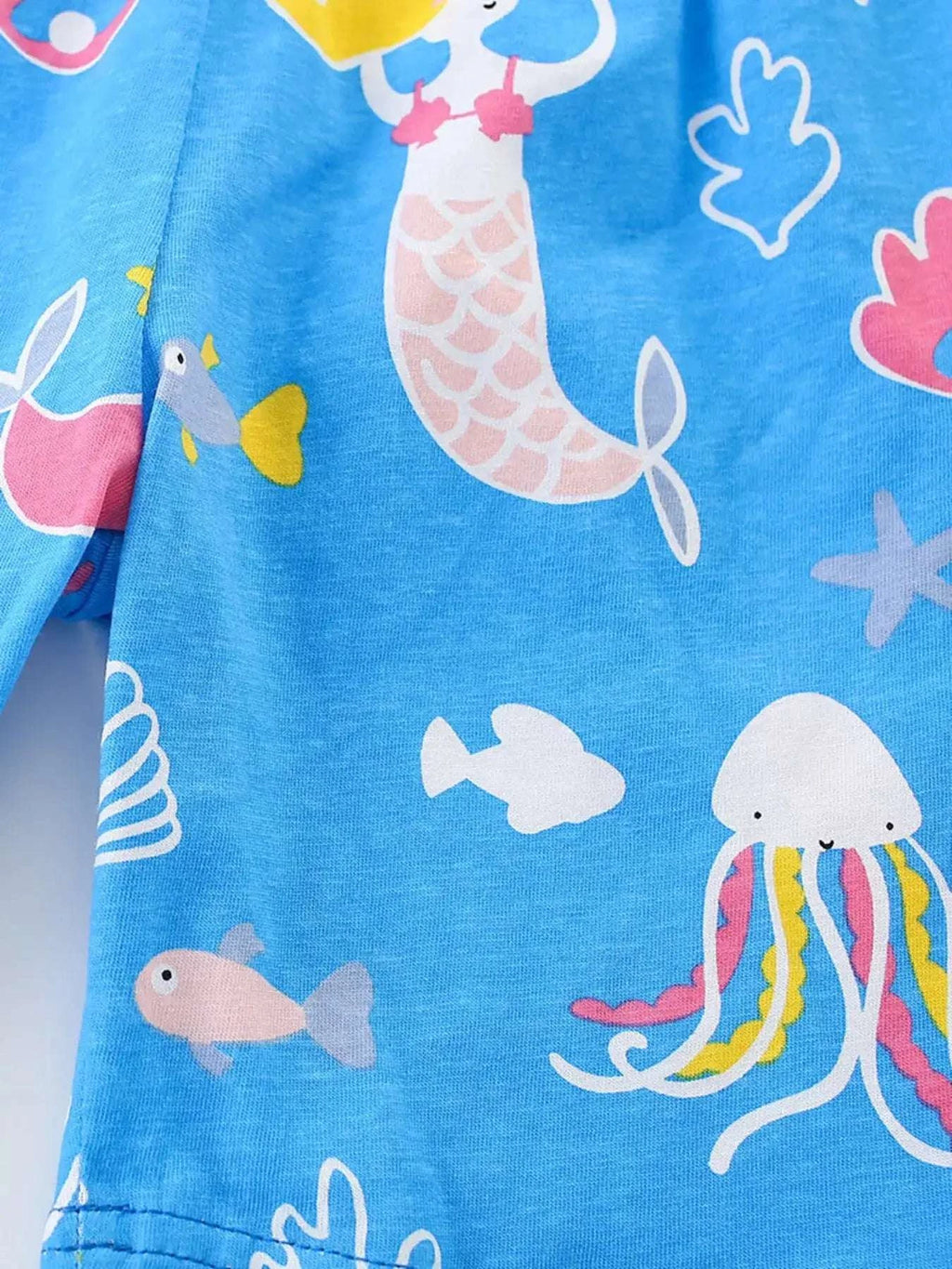 Sky-blue ocean print top with whales, fish, and seashell shapes