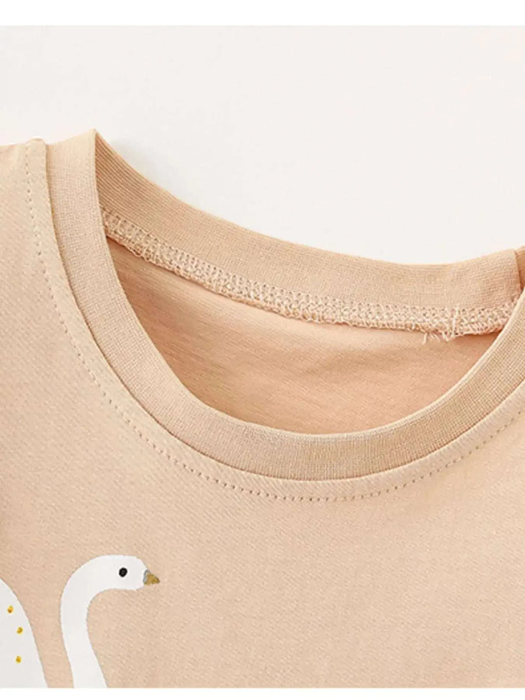 Apricot children’s ruffle sleeve top with crew neckline and stitched trim