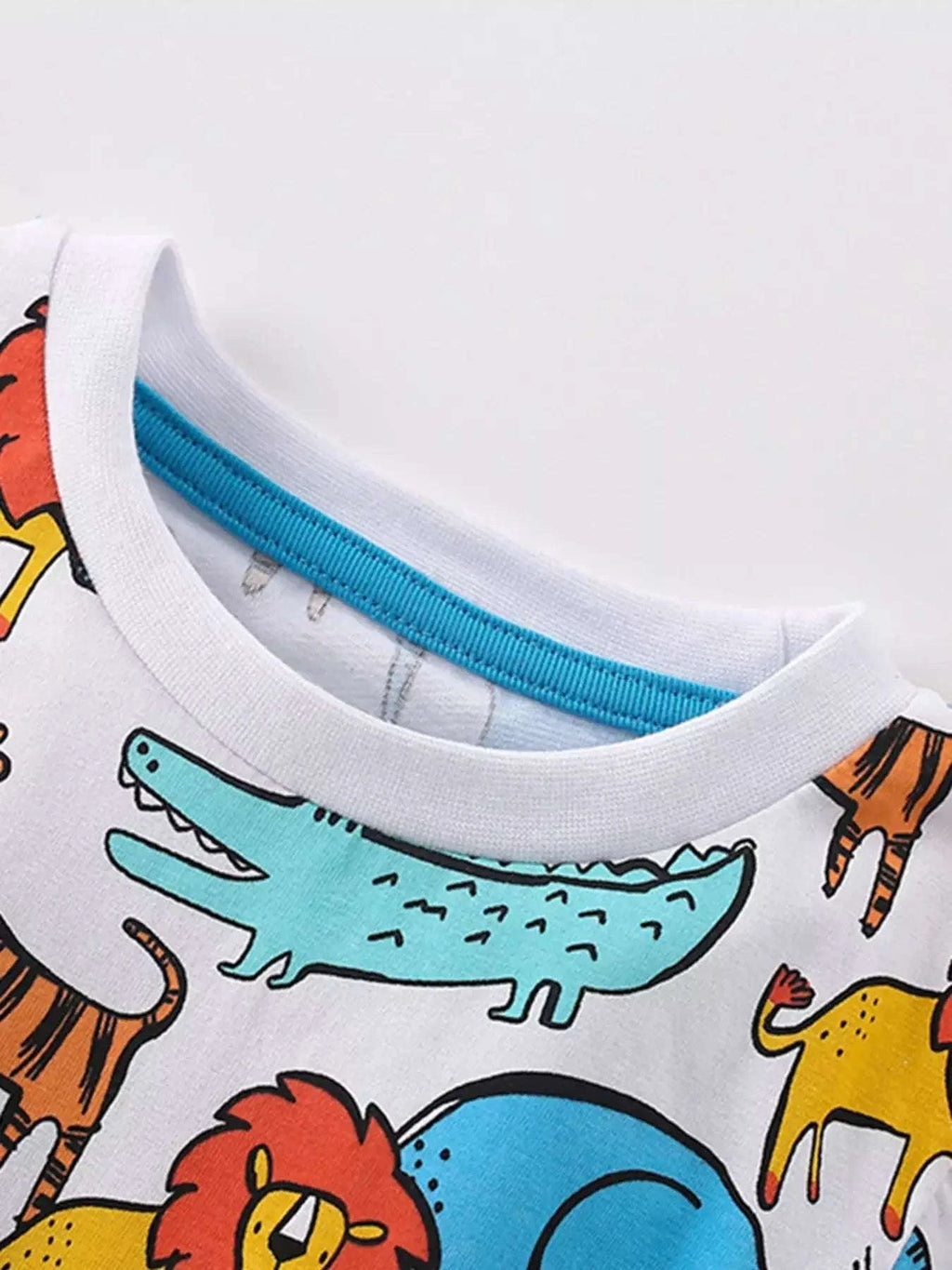 Childrens tee neckline with white ribbed collar and teal trim, animal print