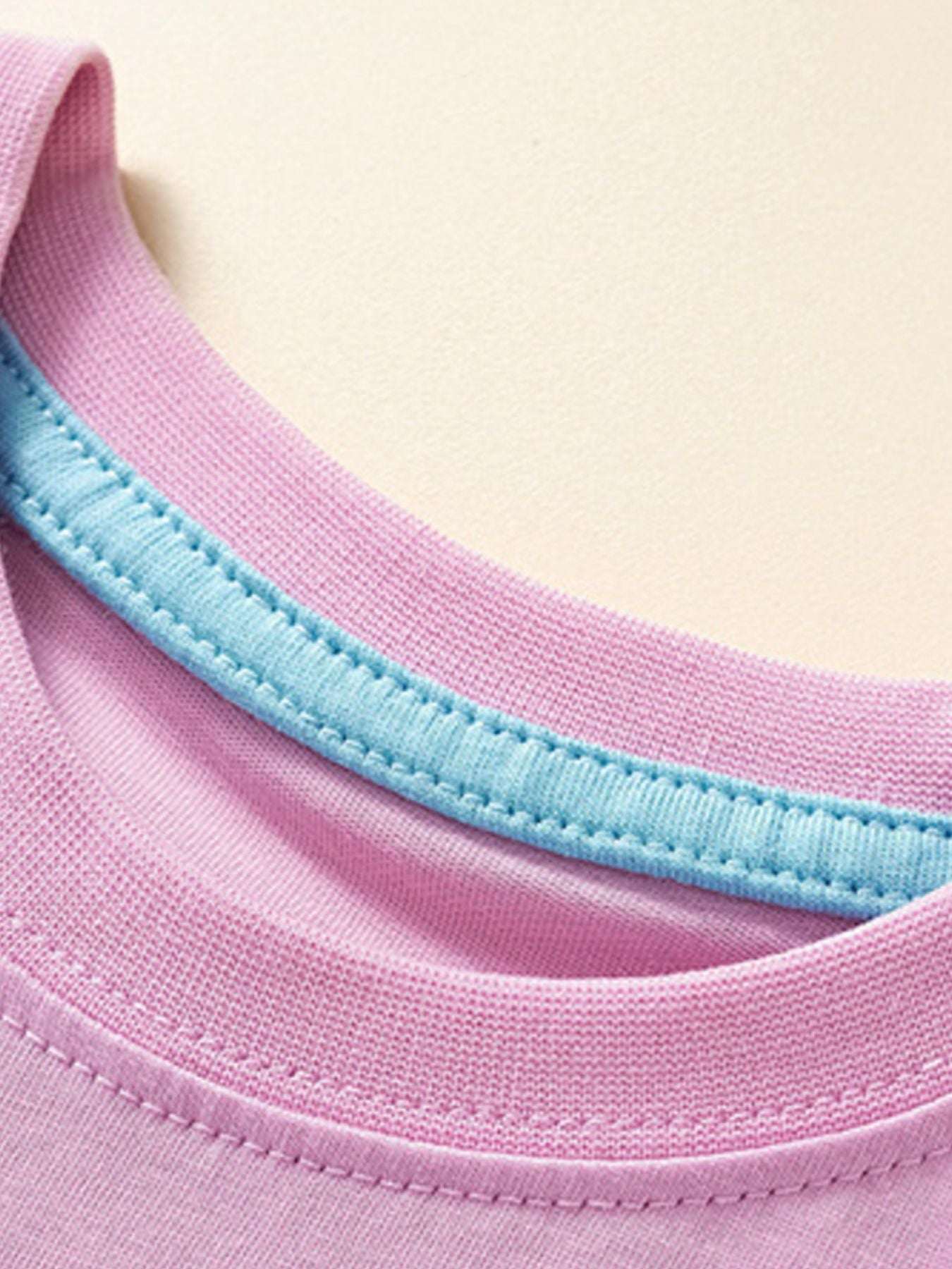 Dusty pink crew neck T-shirt with light blue collar binding and stitched hem