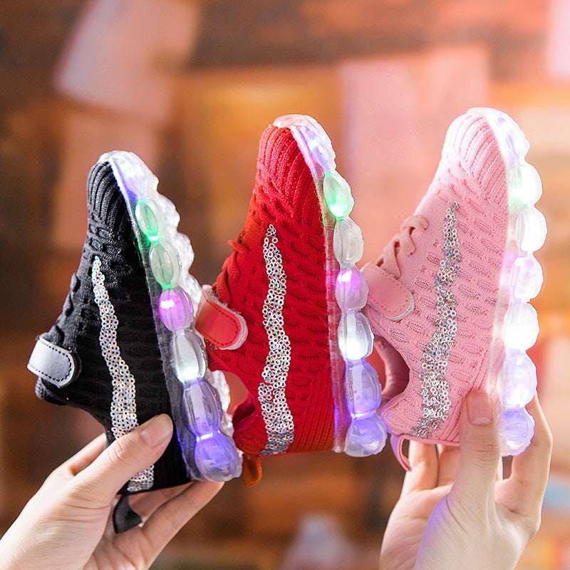 Kids' LED light sneakers pair held up: black and red, mesh knit uppers with glowing soles