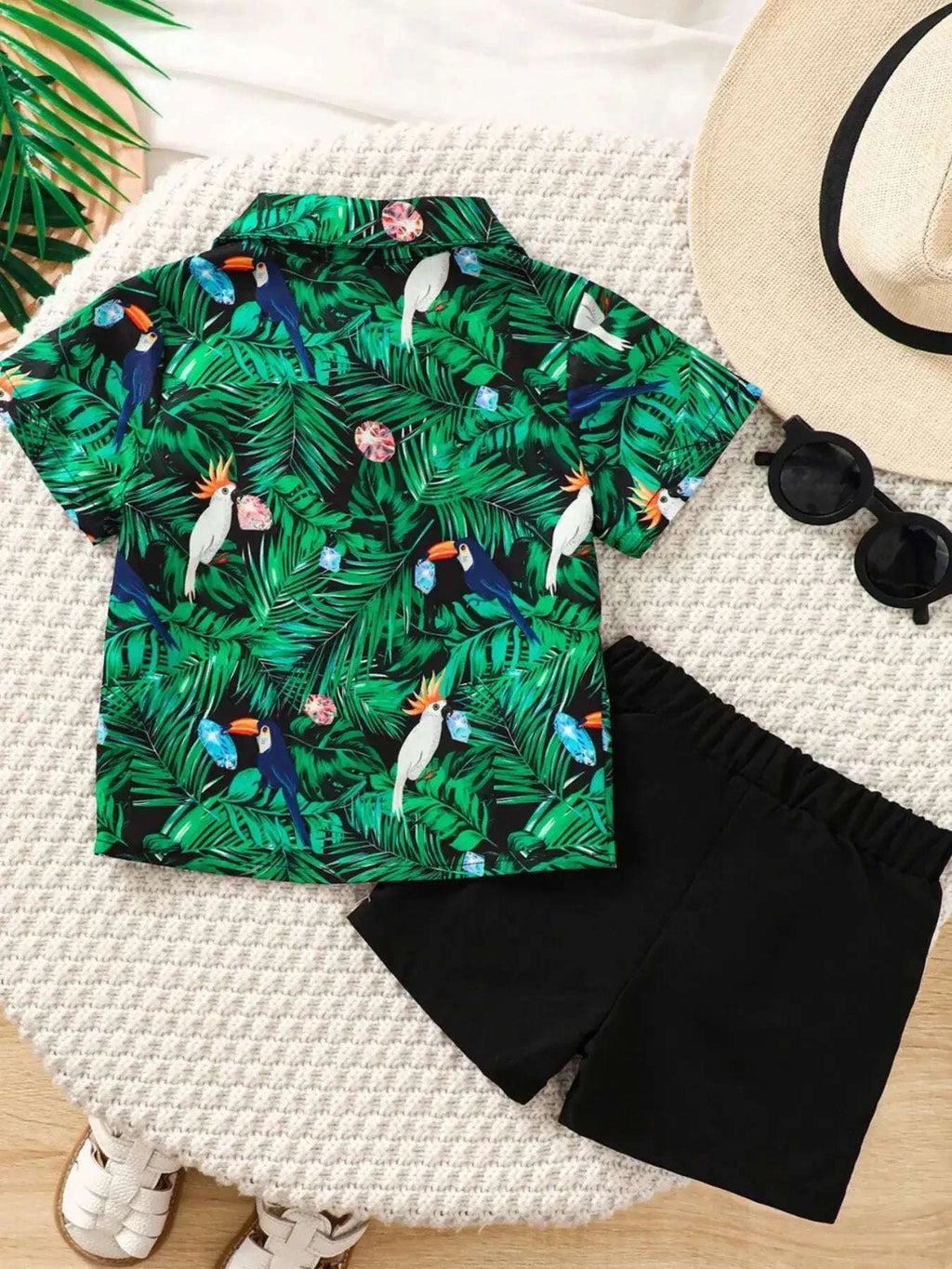 Kids tropical print shirt set: green button-up with black bow tie and black shorts.