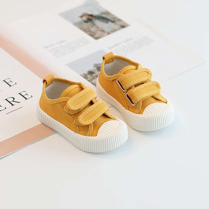 Baby canvas sneakers with hook-and-loop straps, golden yellow uppers and white sole