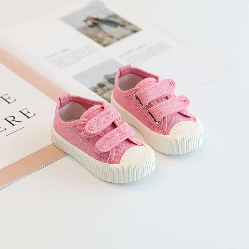 Baby canvas sneakers with hook-and-loop straps, pink uppers and white sole