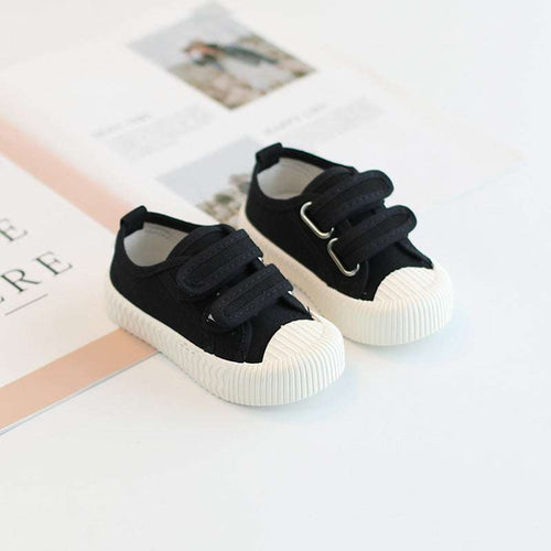 Baby canvas sneakers with hook-and-loop straps, black uppers and white sole