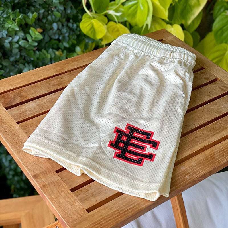Boys mesh sports shorts, cream with elastic waistband and side graphic logo patch