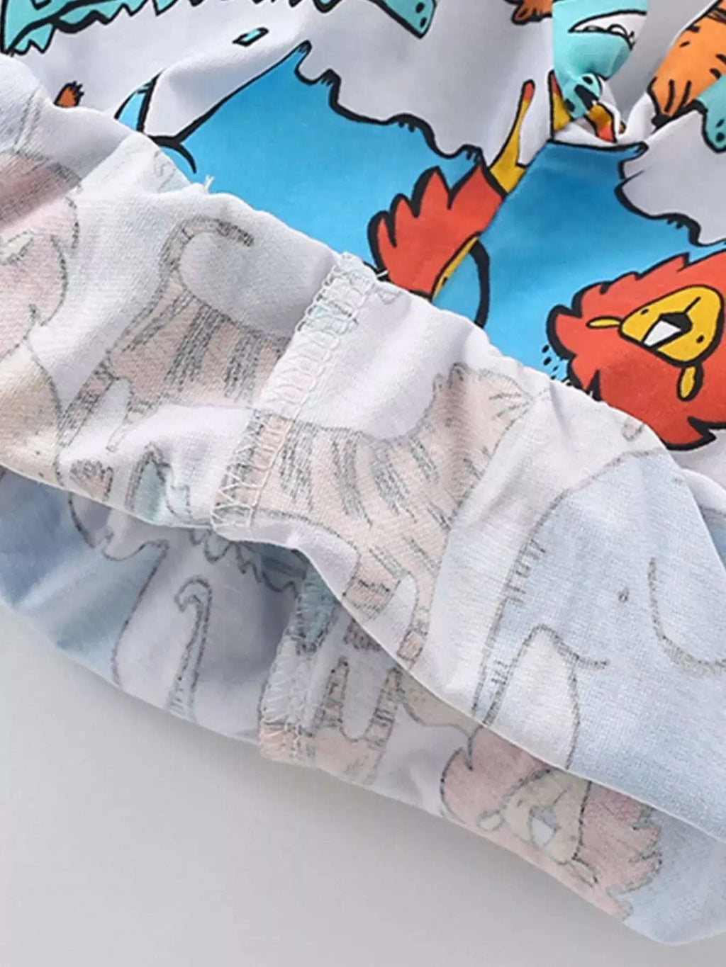 Childrens shorts with elastic waistband and animal print on a light pastel base