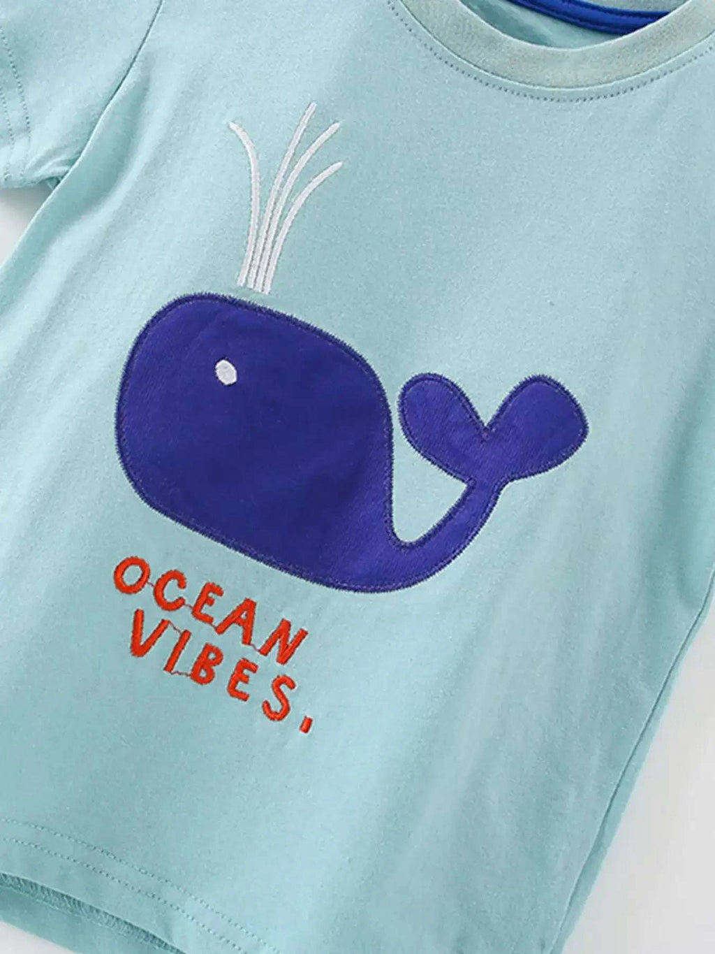 Light blue kids' T-shirt with whale graphic and 'Ocean Vibes' text