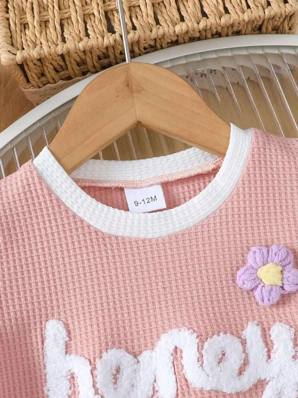 Pink waffle-knit kids tee with white rib collar trim and “honey” embroidery
