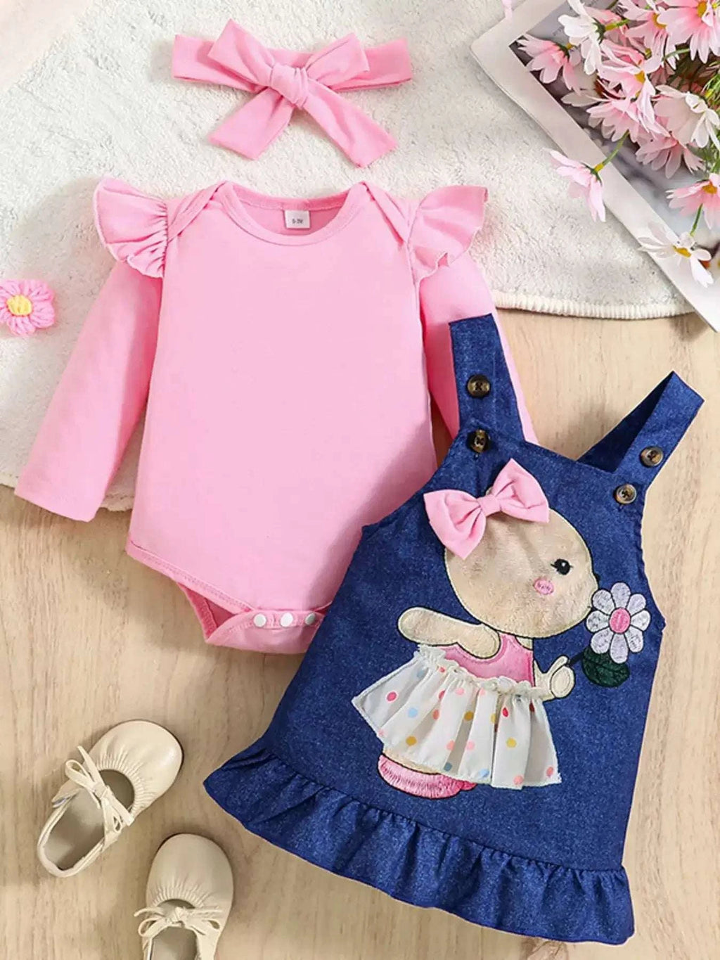 Pink bodysuit with navy overall dress, rabbit graphic, bow-front and ruffle hem