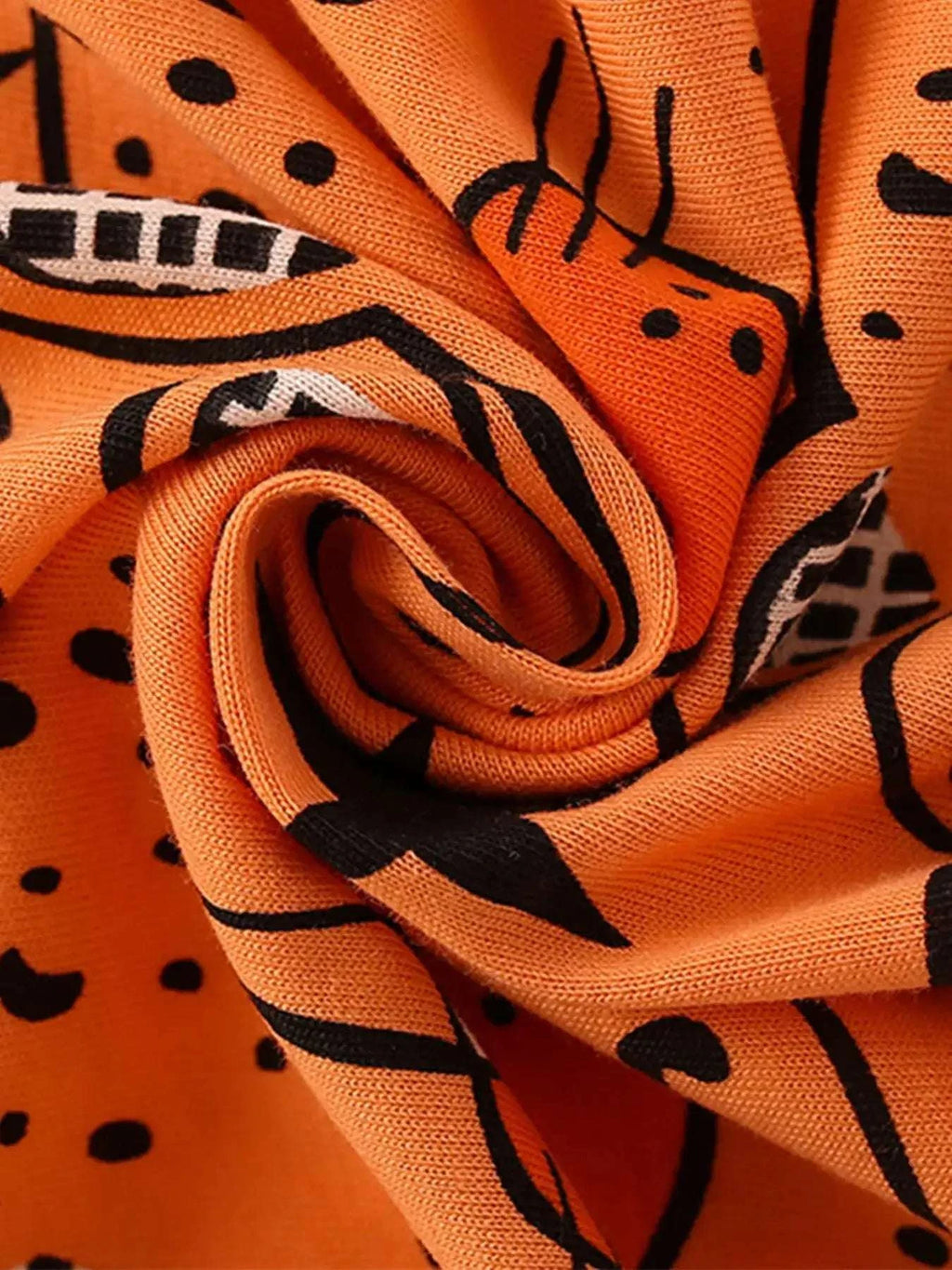 Orange bear-print knit fabric with curled pattern and black star motifs