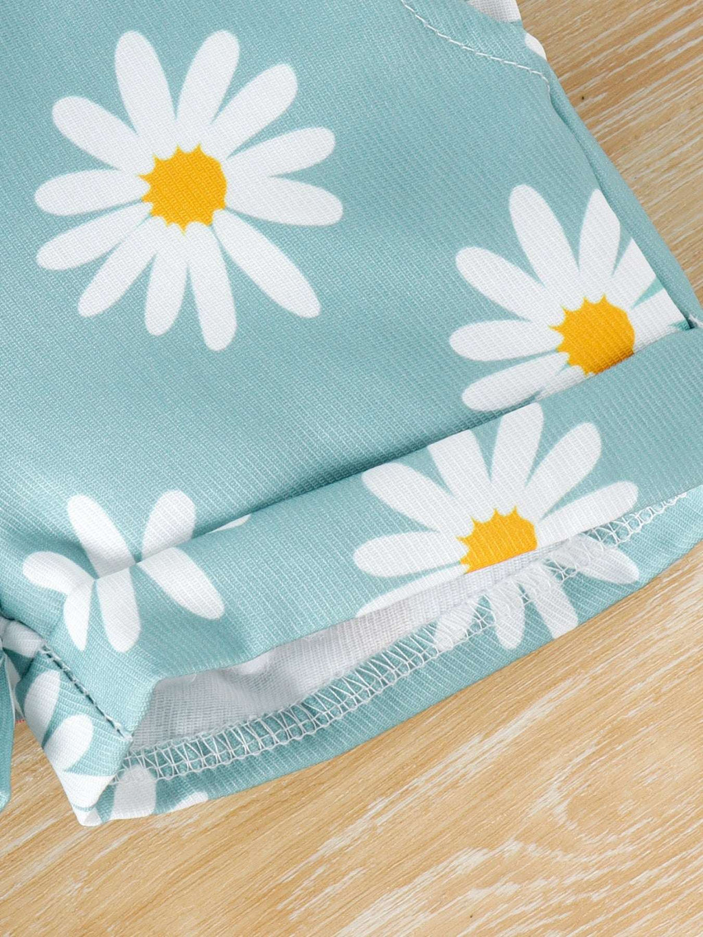 Light blue daisy print overalls with elasticized gathered leg hem detail