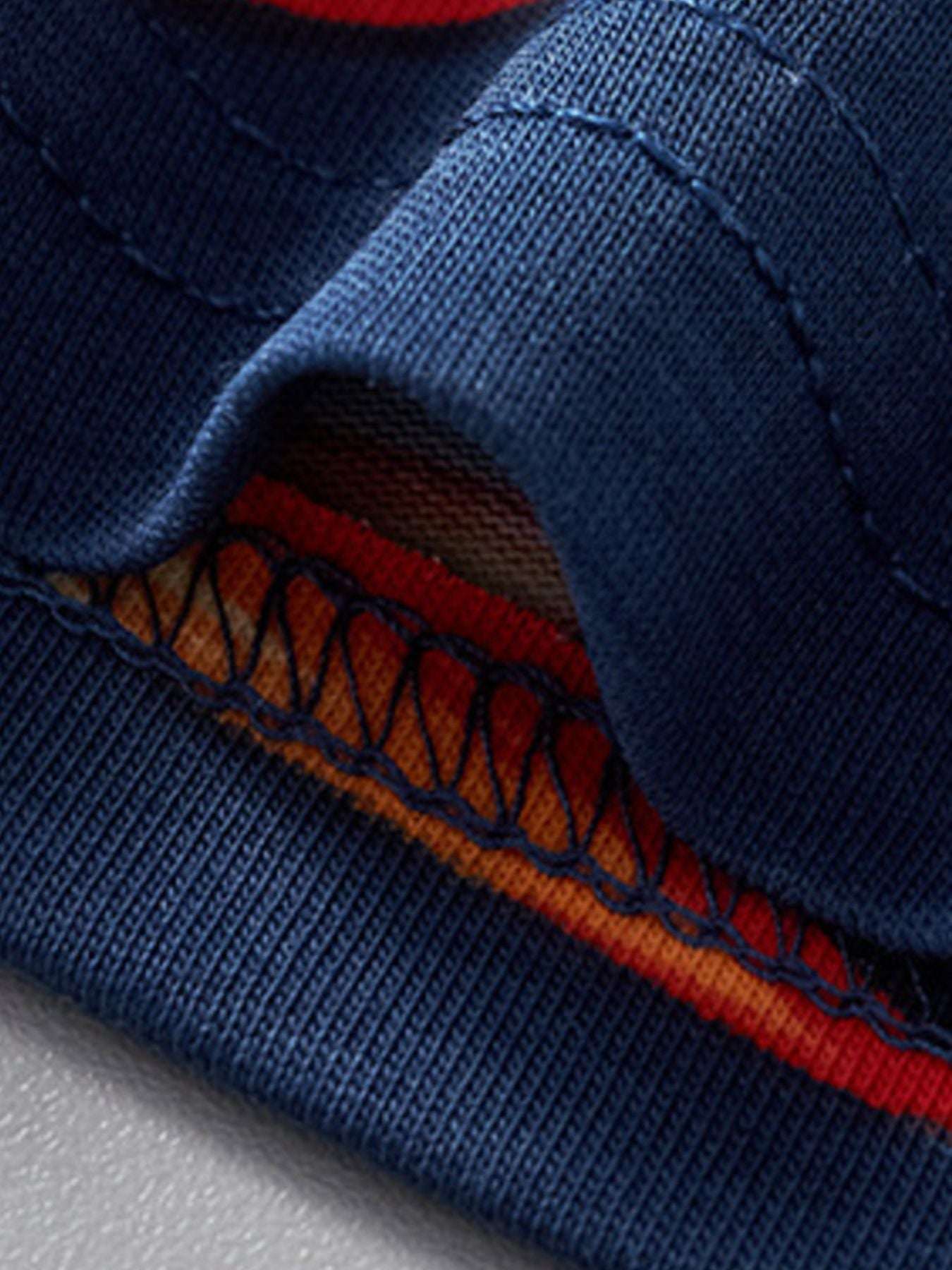 Navy T-shirt hem with stitched trim detail in orange and blue