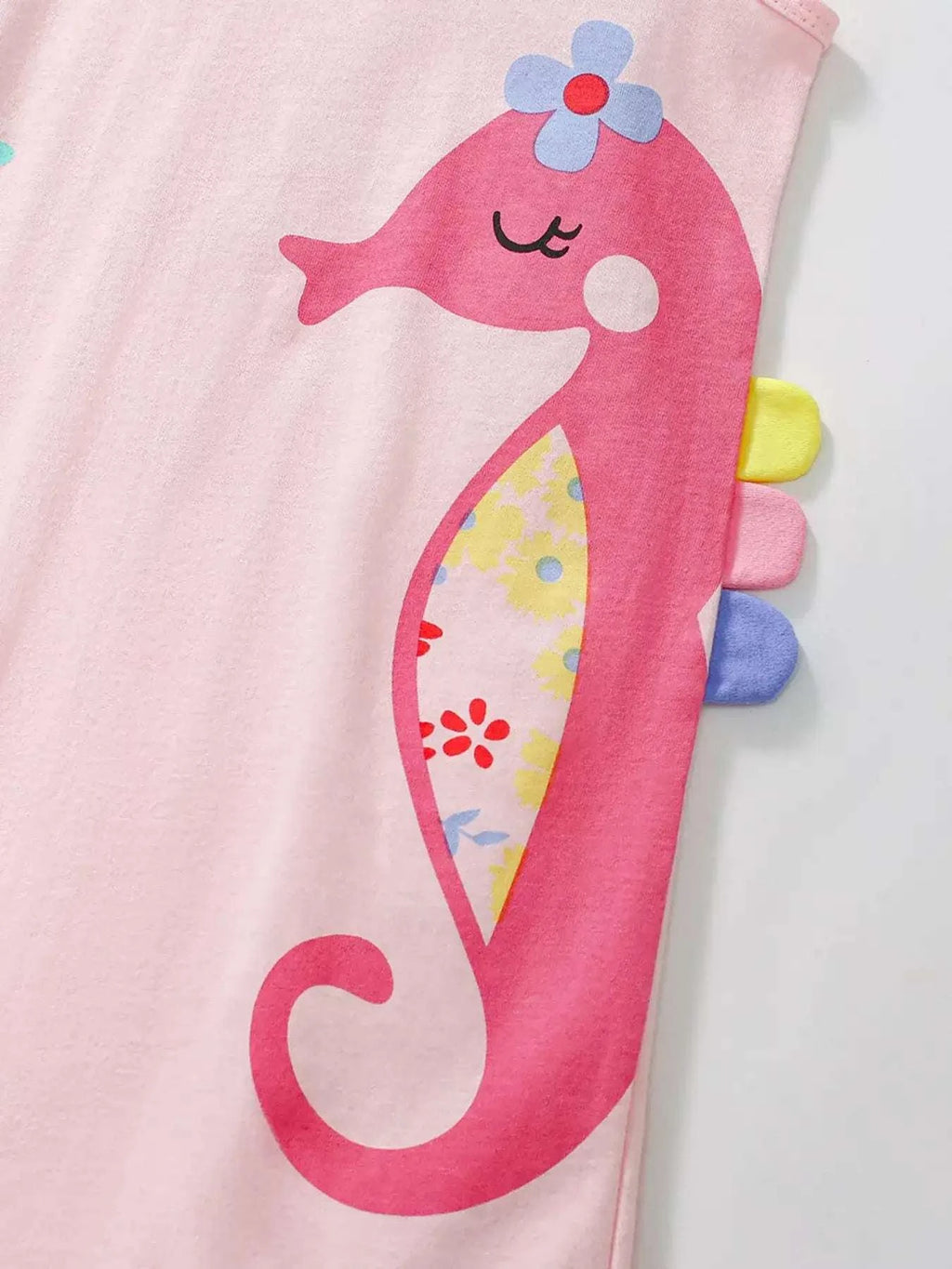 Blush pink sleeveless dress with pink seahorse graphic and ruffle neckline
