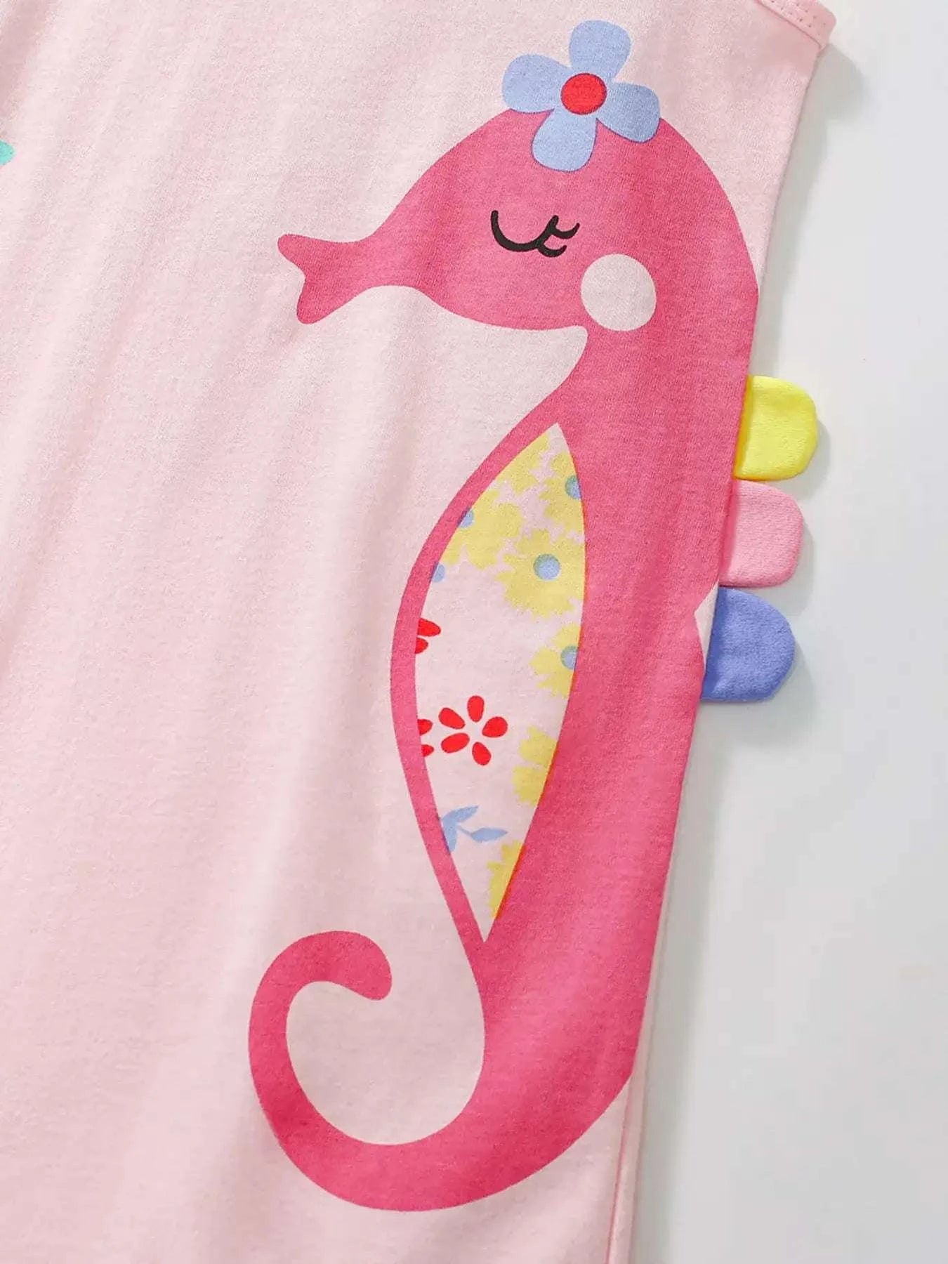 Blush pink sleeveless dress with pink seahorse graphic and ruffle neckline