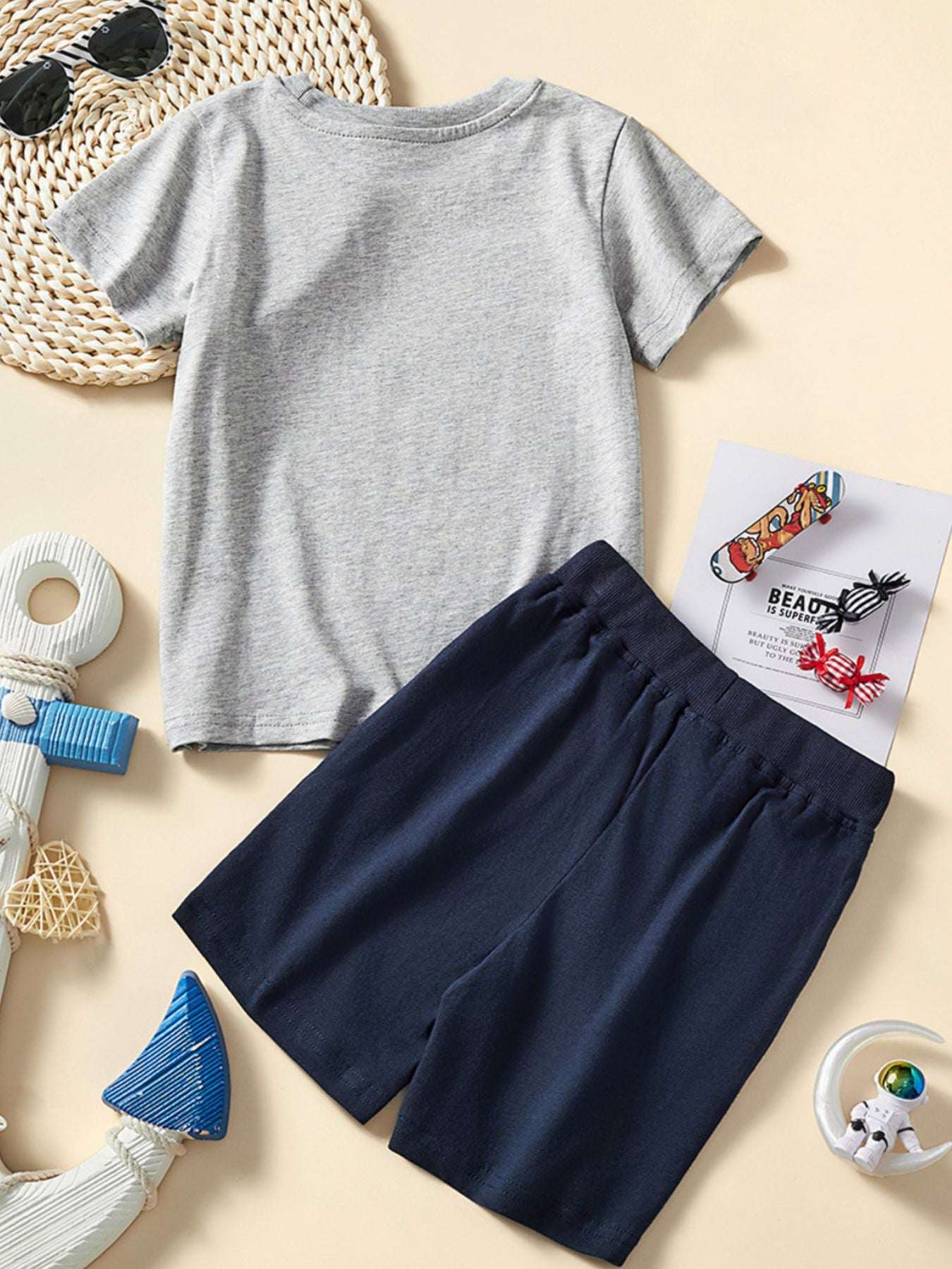 Children's gray tee and navy shorts set with ship graphic, front view