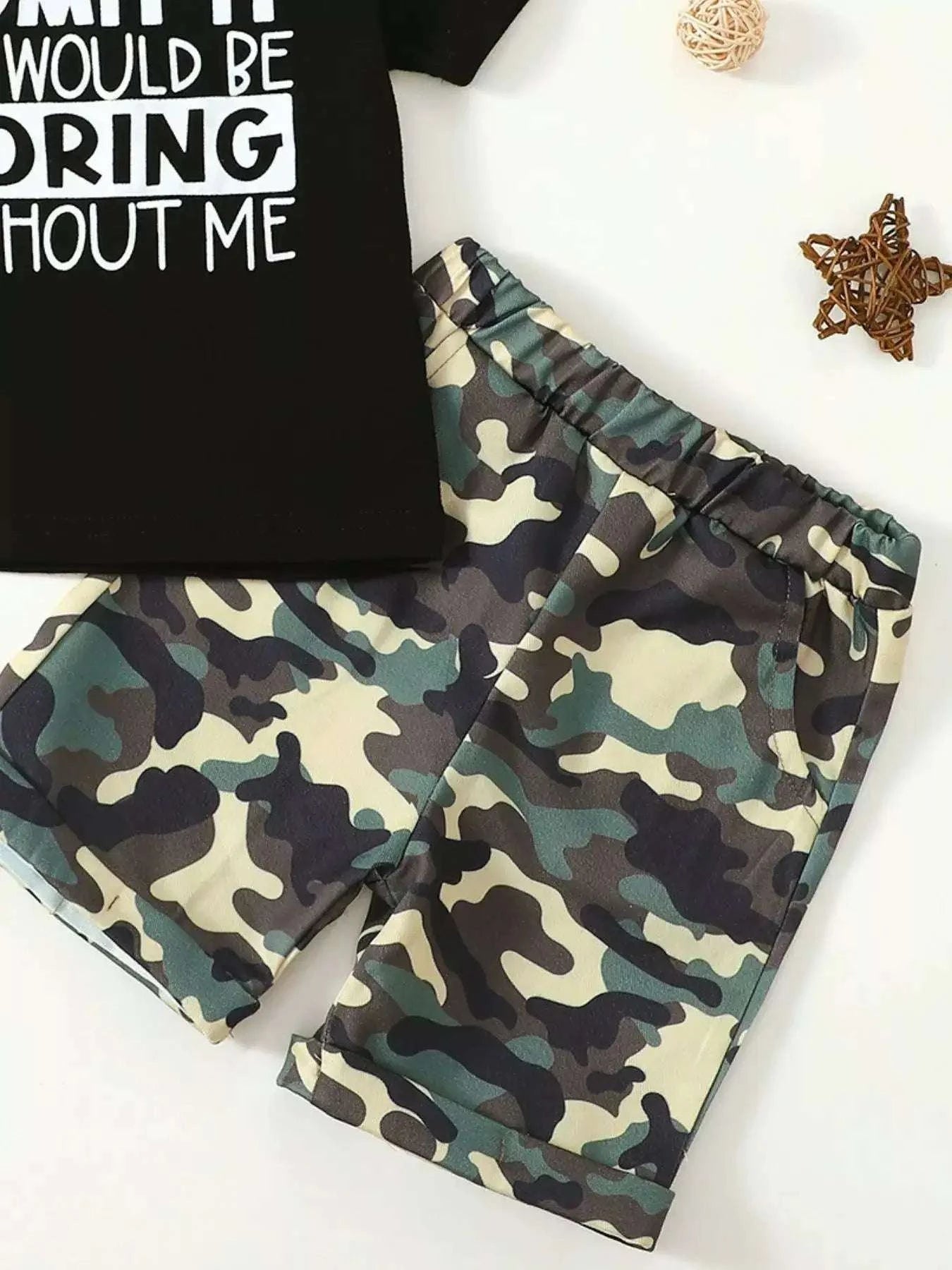 Kids black graphic tee and camouflage shorts set, close view with "WOULD BE BORING" text