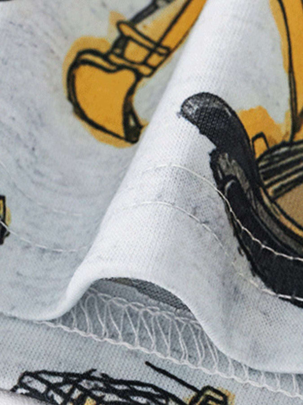 Kids tee sleeve hem with stitched cuff and white background, featuring construction vehicle print