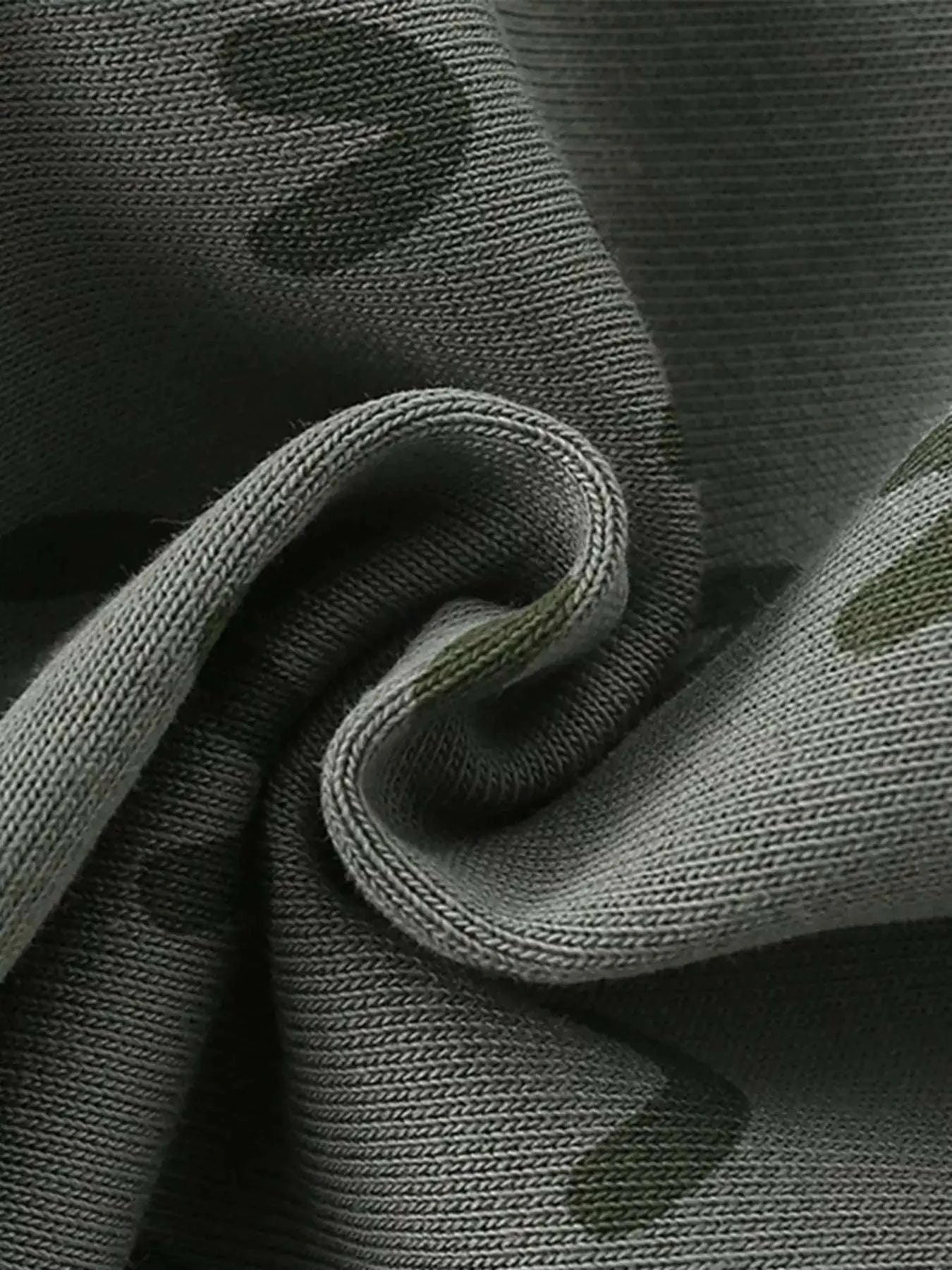 Gray-green cotton shorts fabric close-up with crocodile pattern texture
