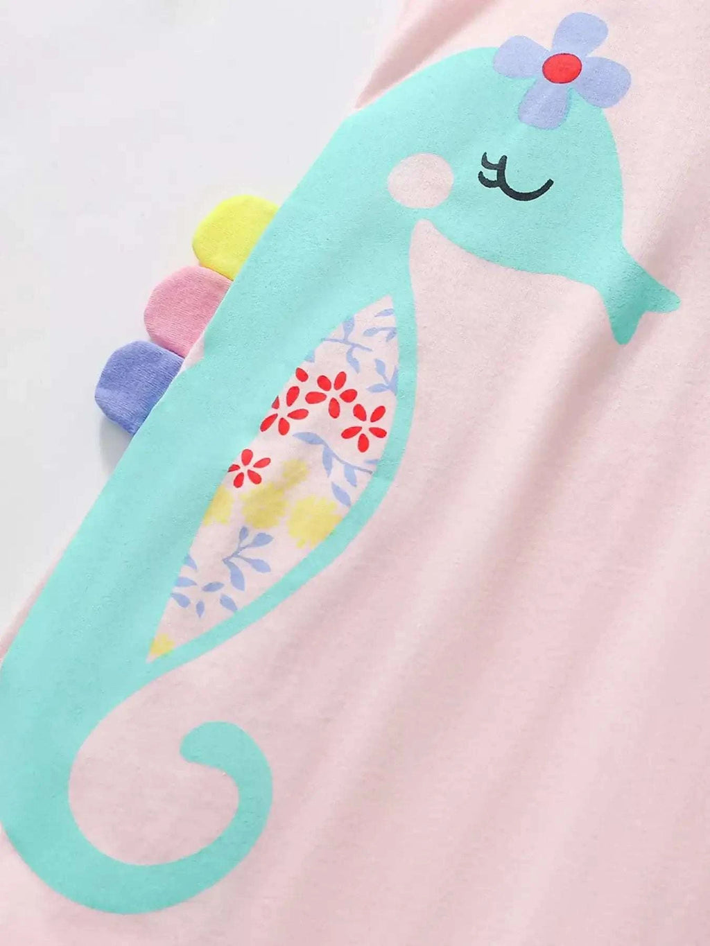 Blush pink sleeveless dress with teal seahorse graphic and ruffle neckline