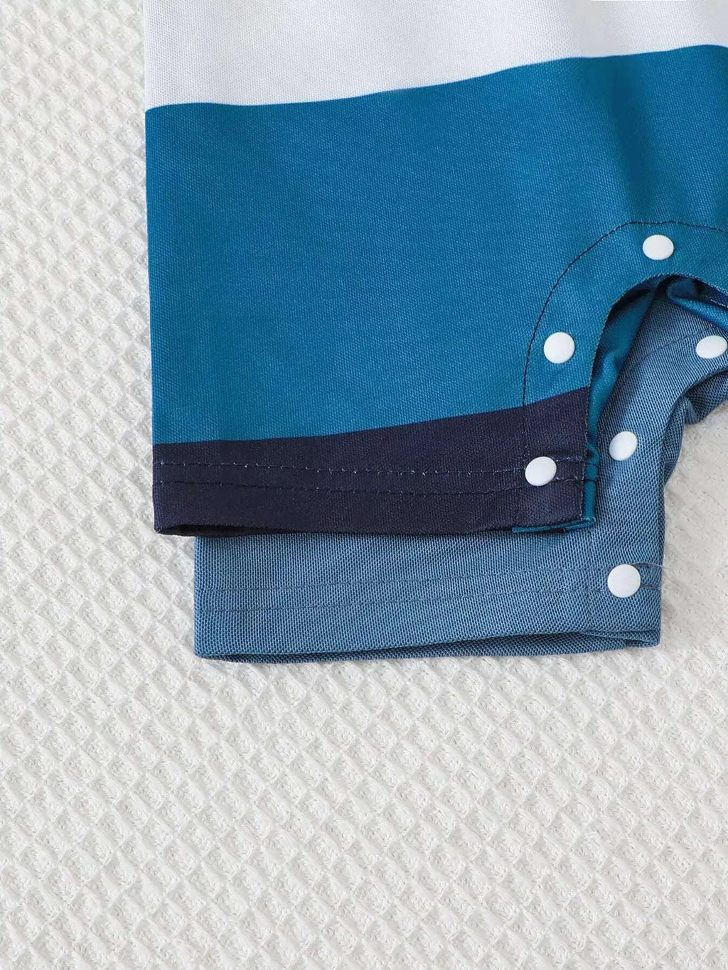 Color-block short-sleeve romper cuffs with blue panel and polka-dot snap buttons
