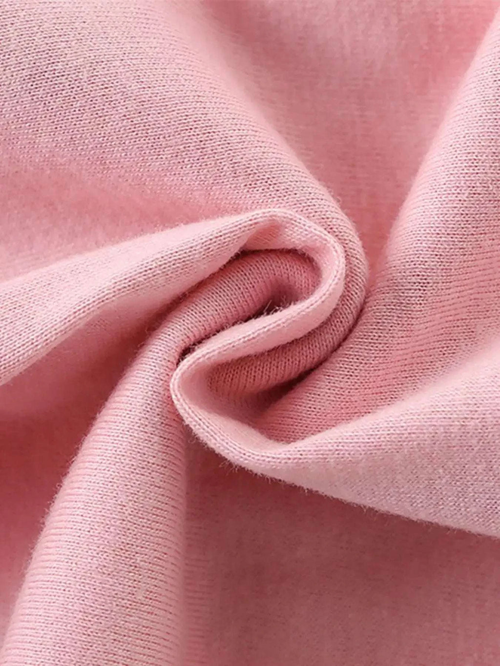 Blush pink kids T-shirt fabric close-up with soft knit texture