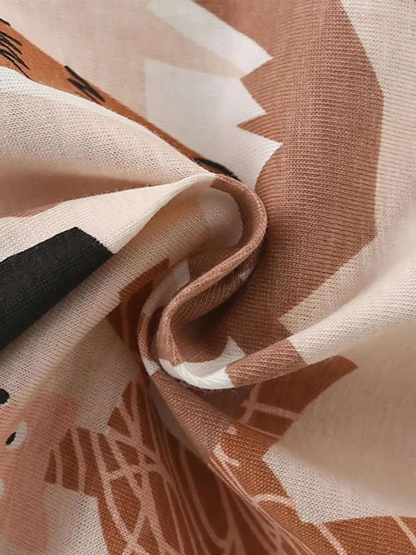 Children's animal print fabric close-up in tan, brown, and black