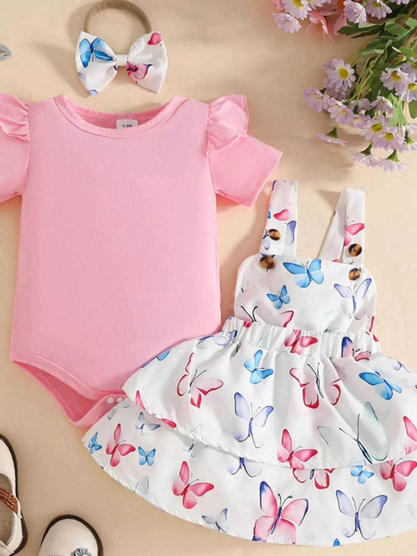 Pink ruffled bodysuit set with butterfly print skirt and multicolor bow headband