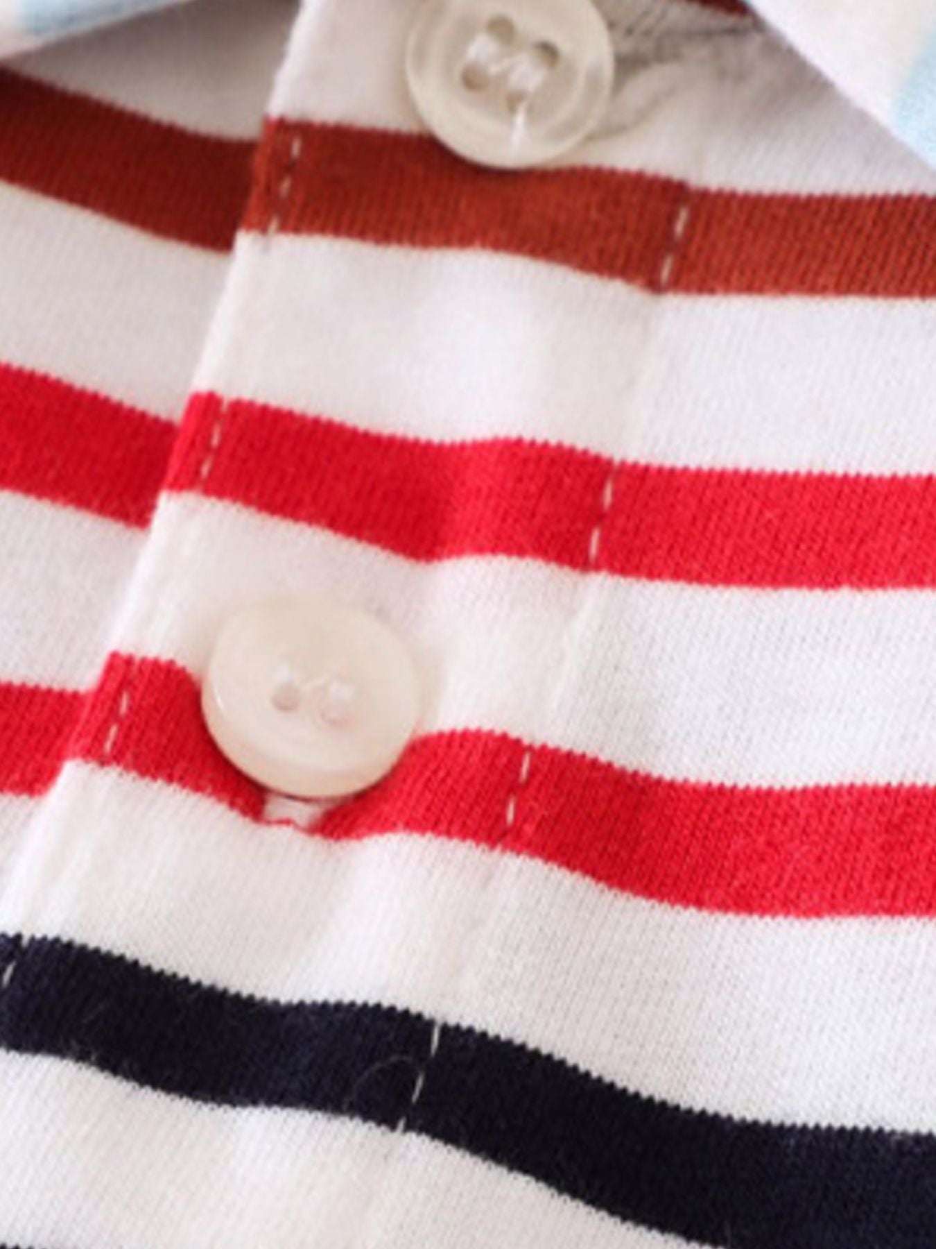 Polo placket close-up with white and red stripes and two white buttons