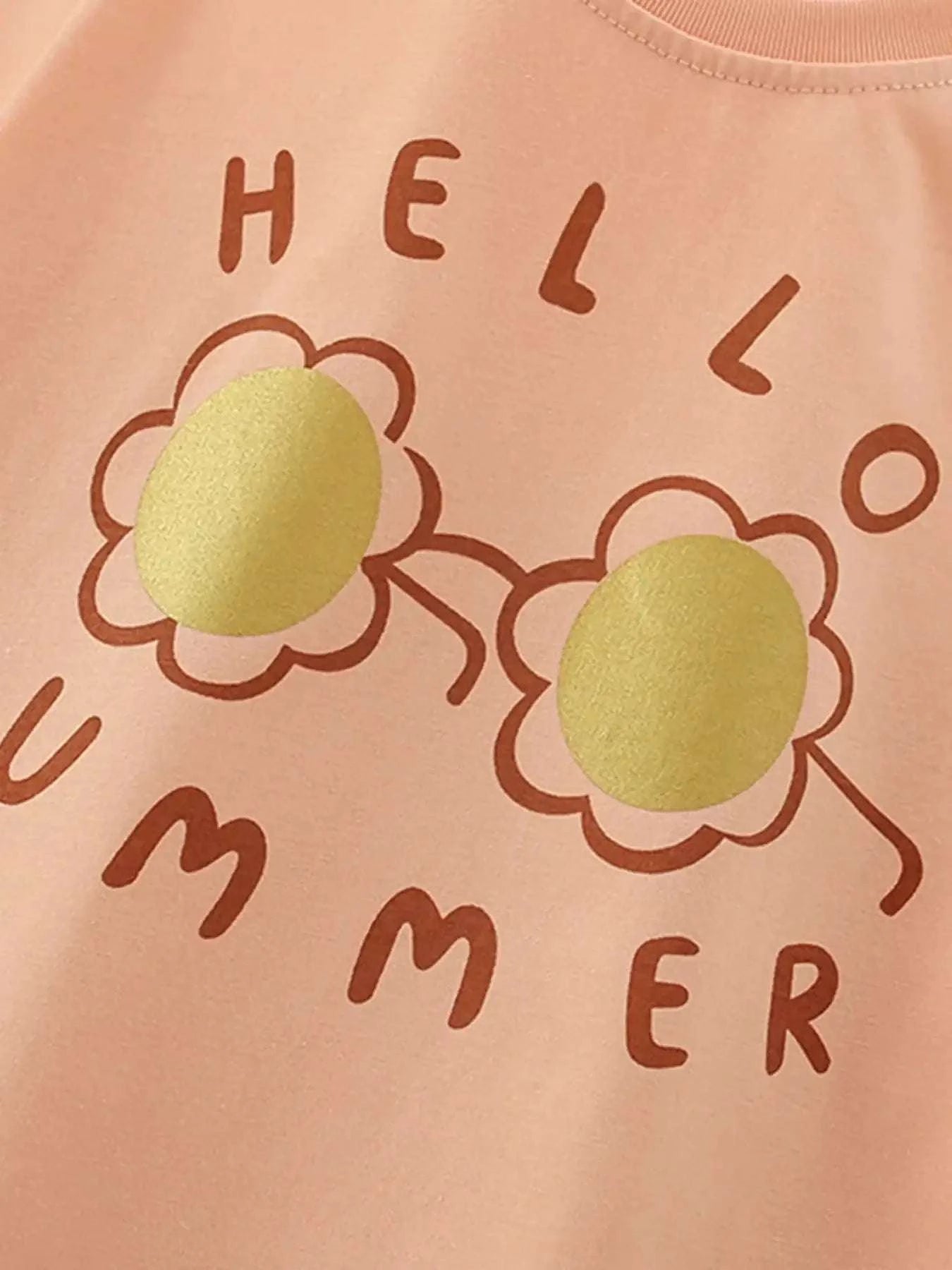 Ruffle-trim children's t-shirt with flower graphic and 'HEL'/'ER' letters on peach