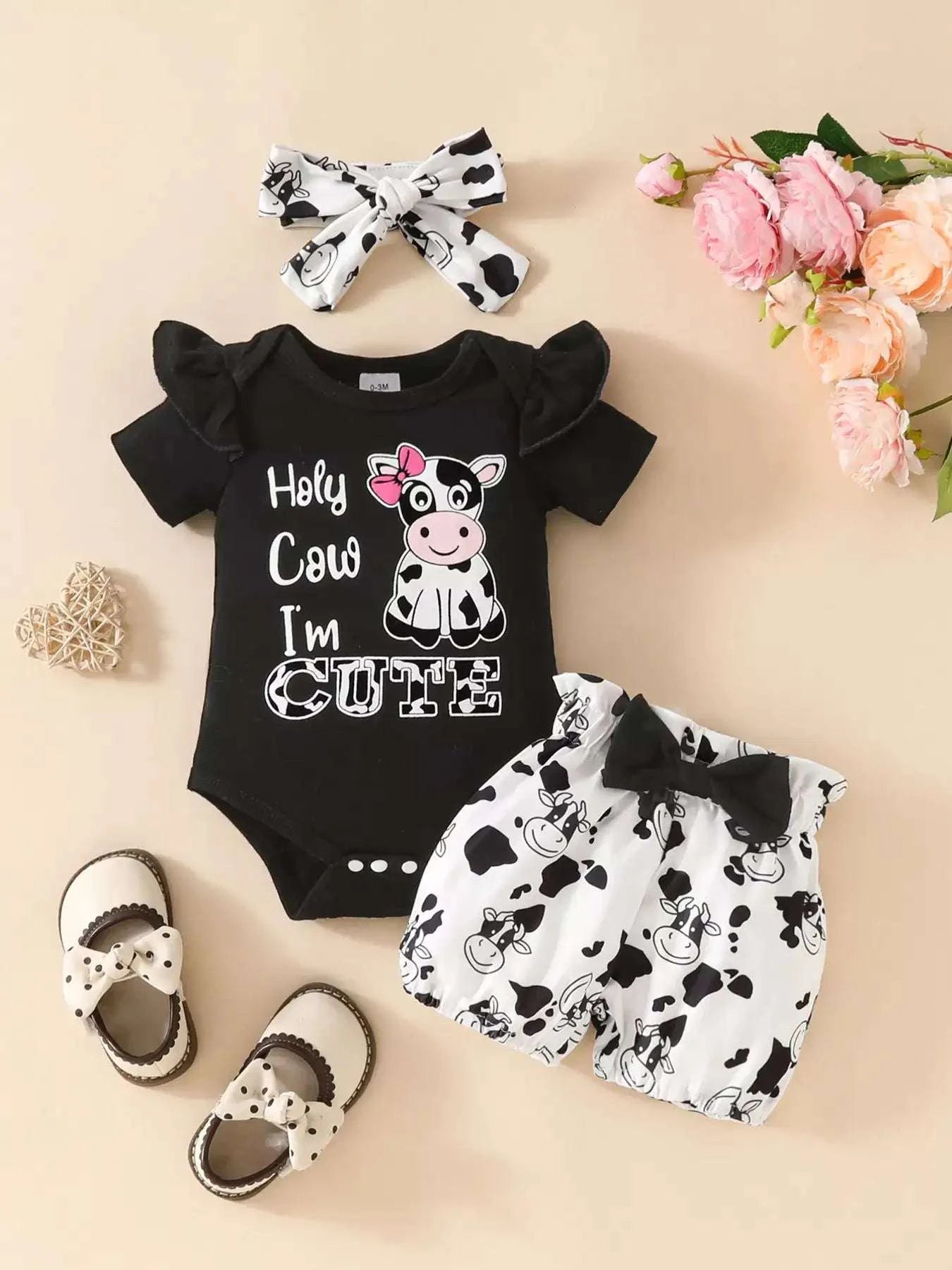 Black ruffled cow bodysuit with cow-print shorts and white bow headband set