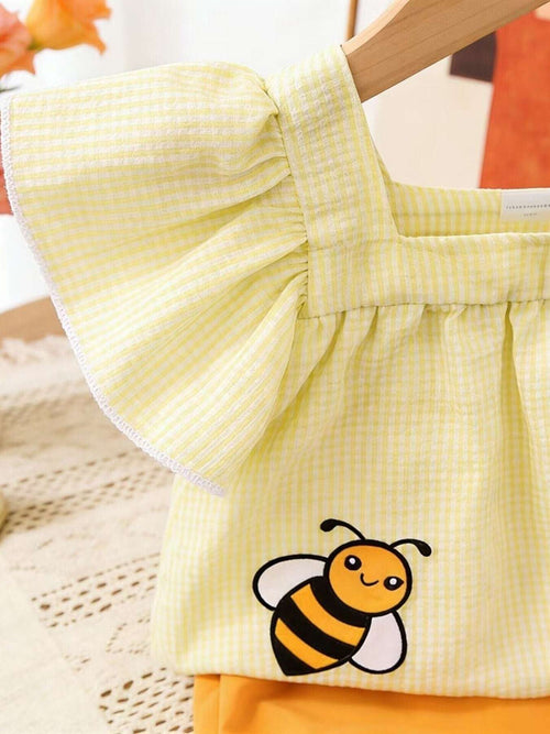 Light yellow gingham top with bee patch and ruffled neckline