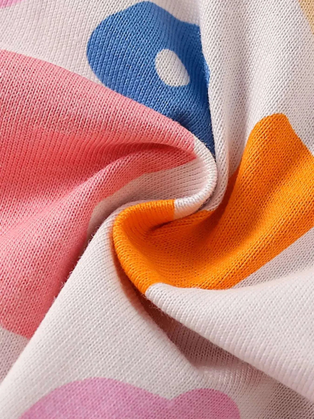 Children's printed knit top fabric in white with orange and blue cloud motifs