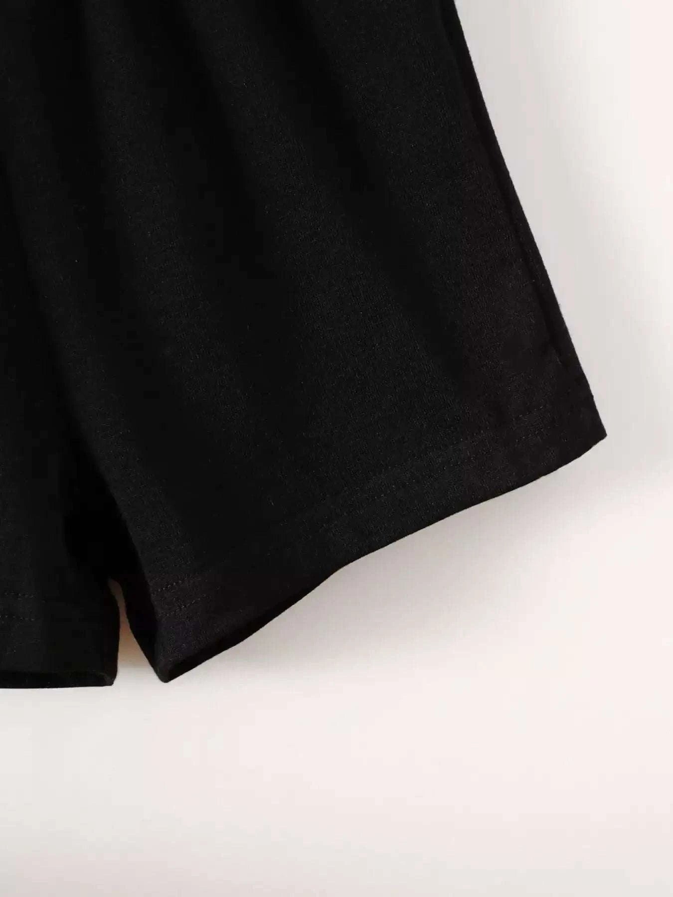 Black shorts with curved hem and soft fabric.