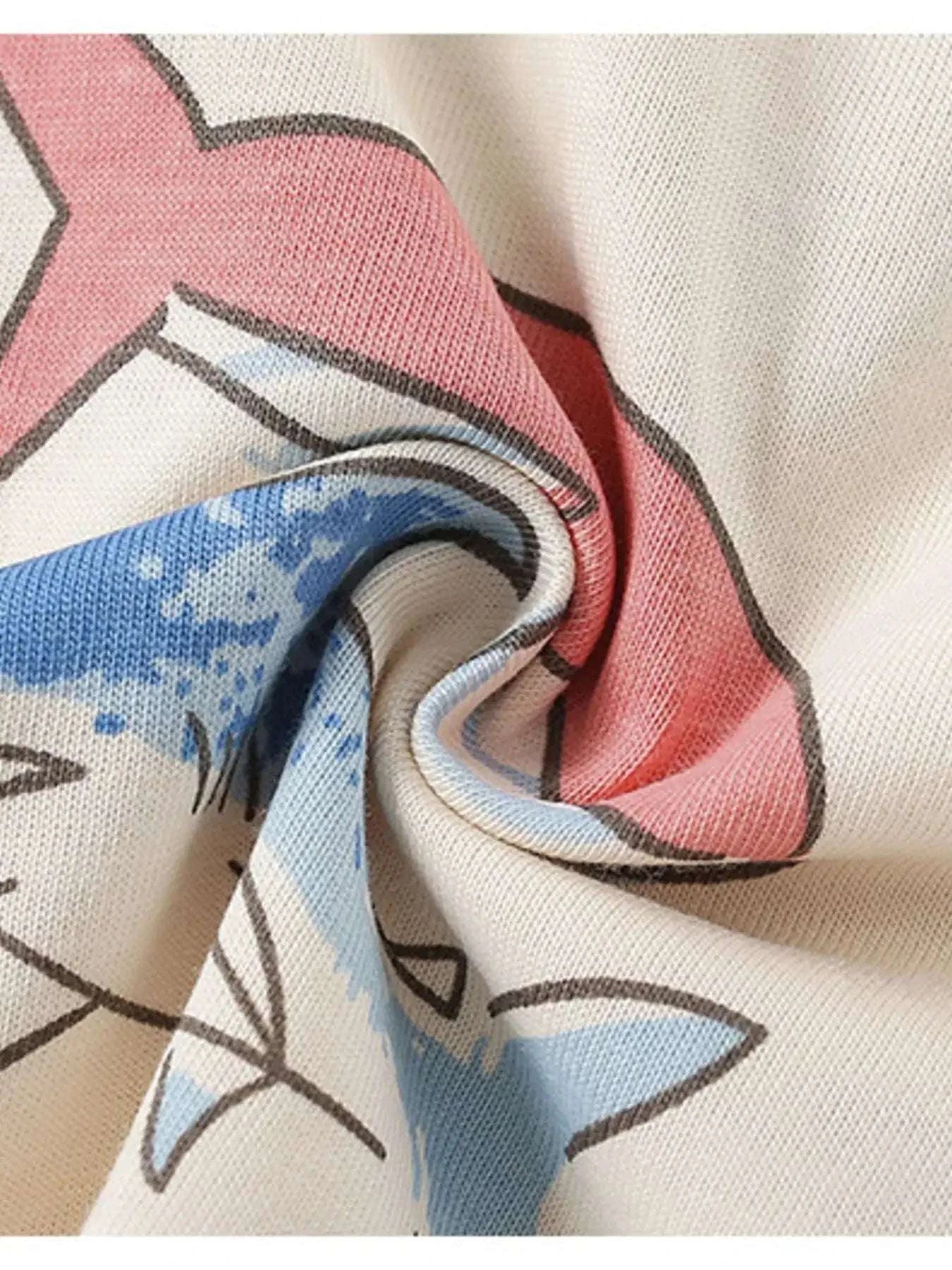 Beige ocean print kids tee fabric close-up with fish and starfish pattern