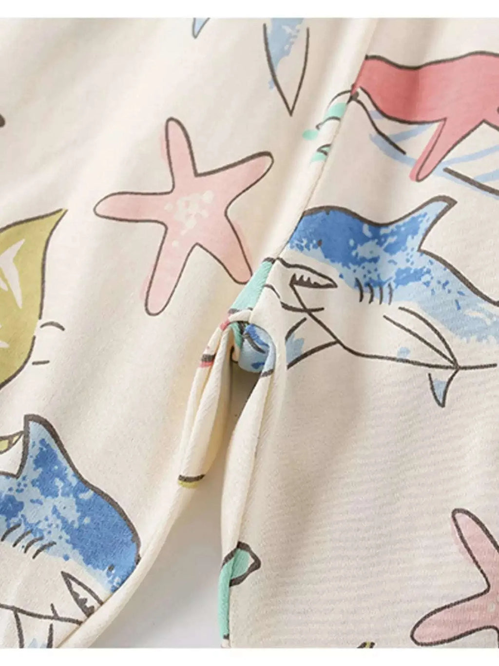Beige ocean print kids tee fabric with starfish and fish illustrations