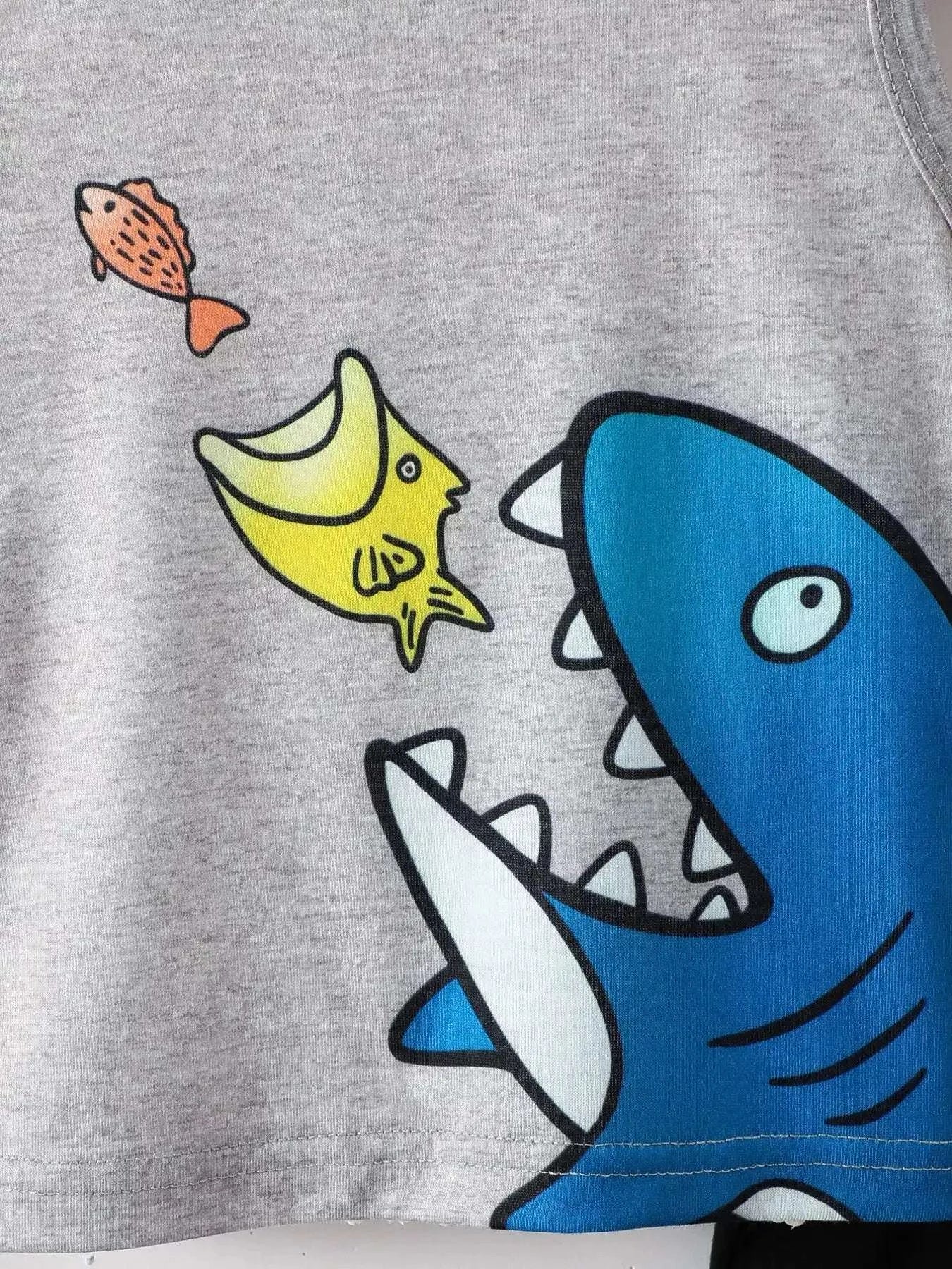 Gray tank top featuring a large blue shark and fish graphic on the front.