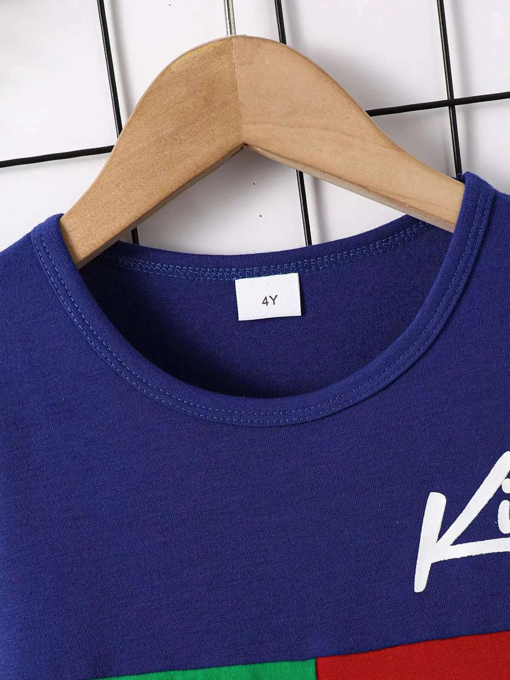 Children's navy-blue round-neck tee with short sleeves and white graphic logo on chest