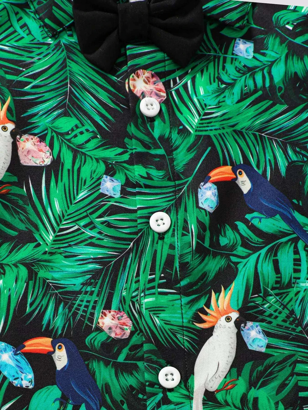 Green tropical leaf print shirt with toucan, parrot, ice-cream motifs; white buttons.