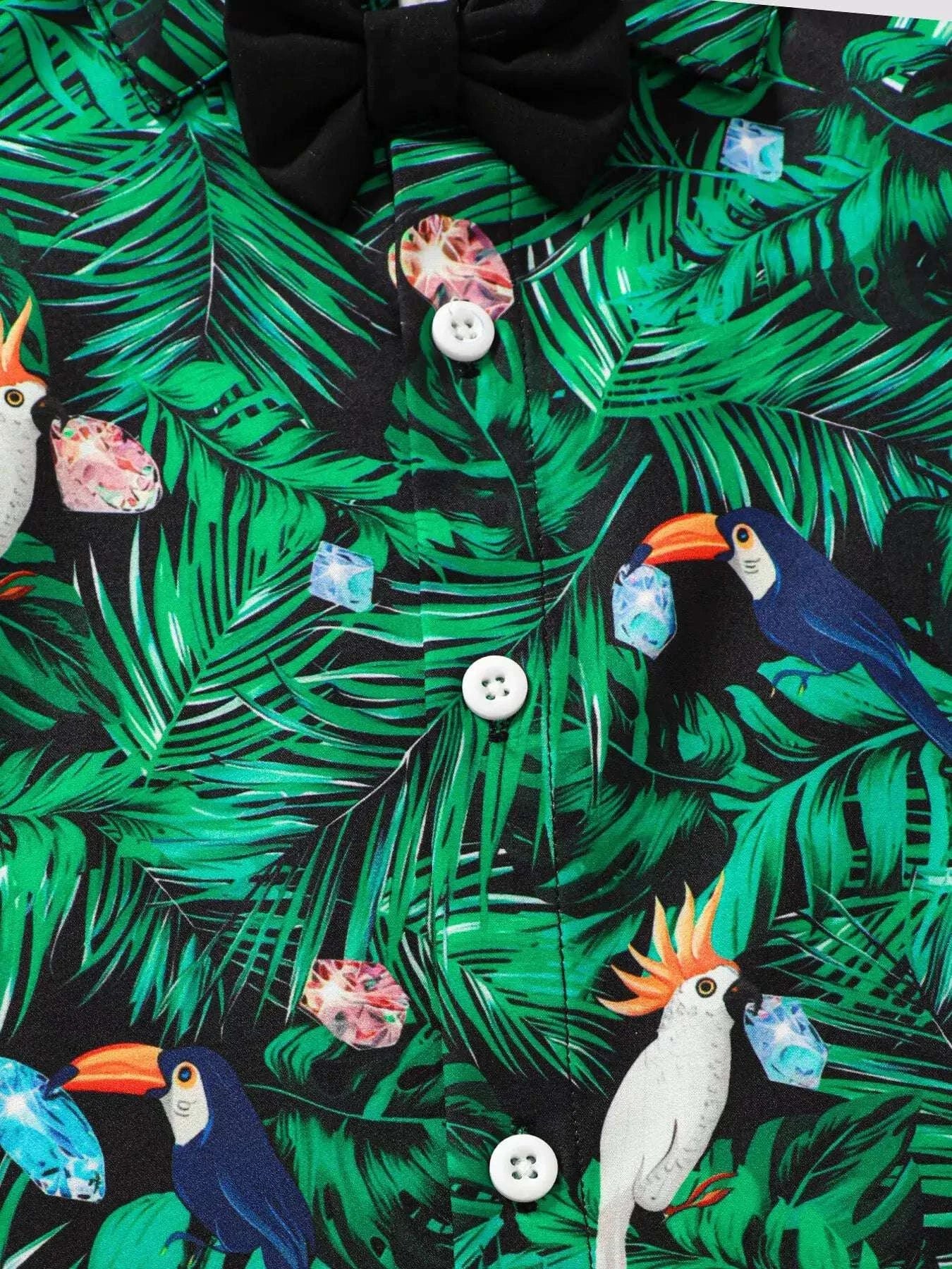 Green tropical leaf print shirt with toucan, parrot, ice-cream motifs; white buttons.