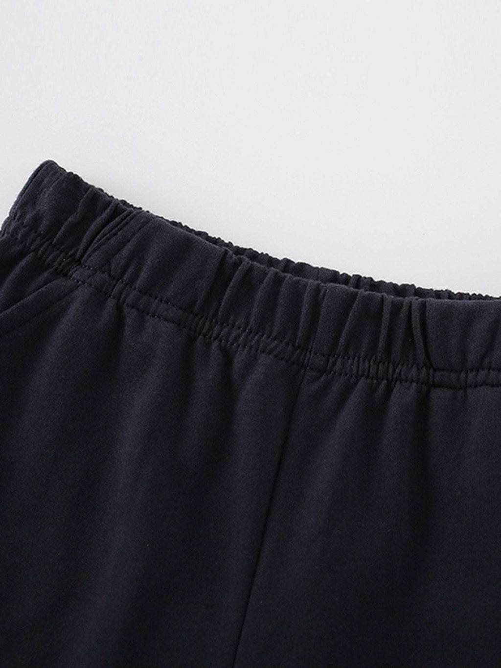 Children's navy shorts close-up: elastic waistband, gathered fabric