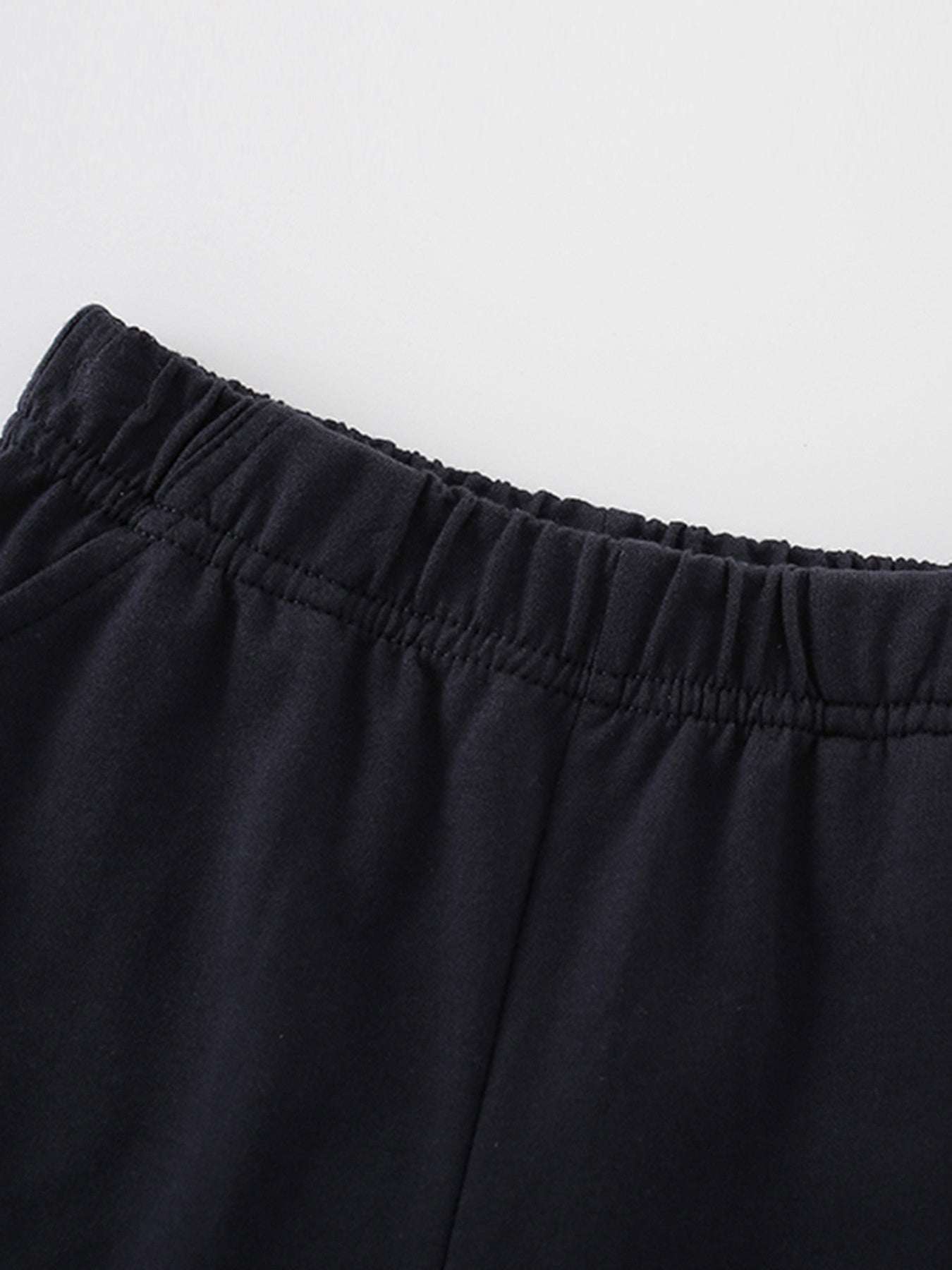 Children's navy shorts close-up: elastic waistband, gathered fabric