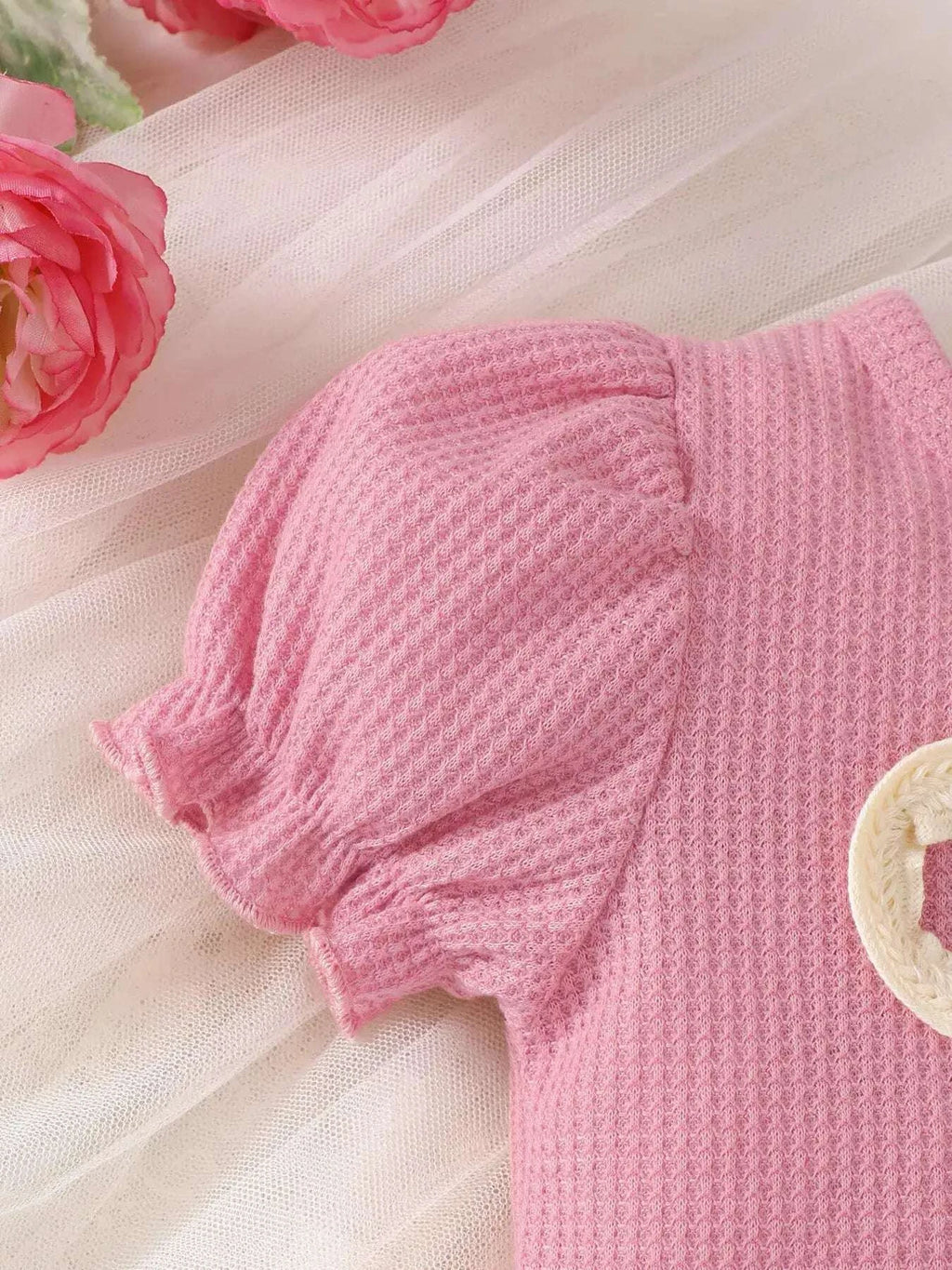 Pink puff-sleeve top with gathered shoulder and elastic neckline