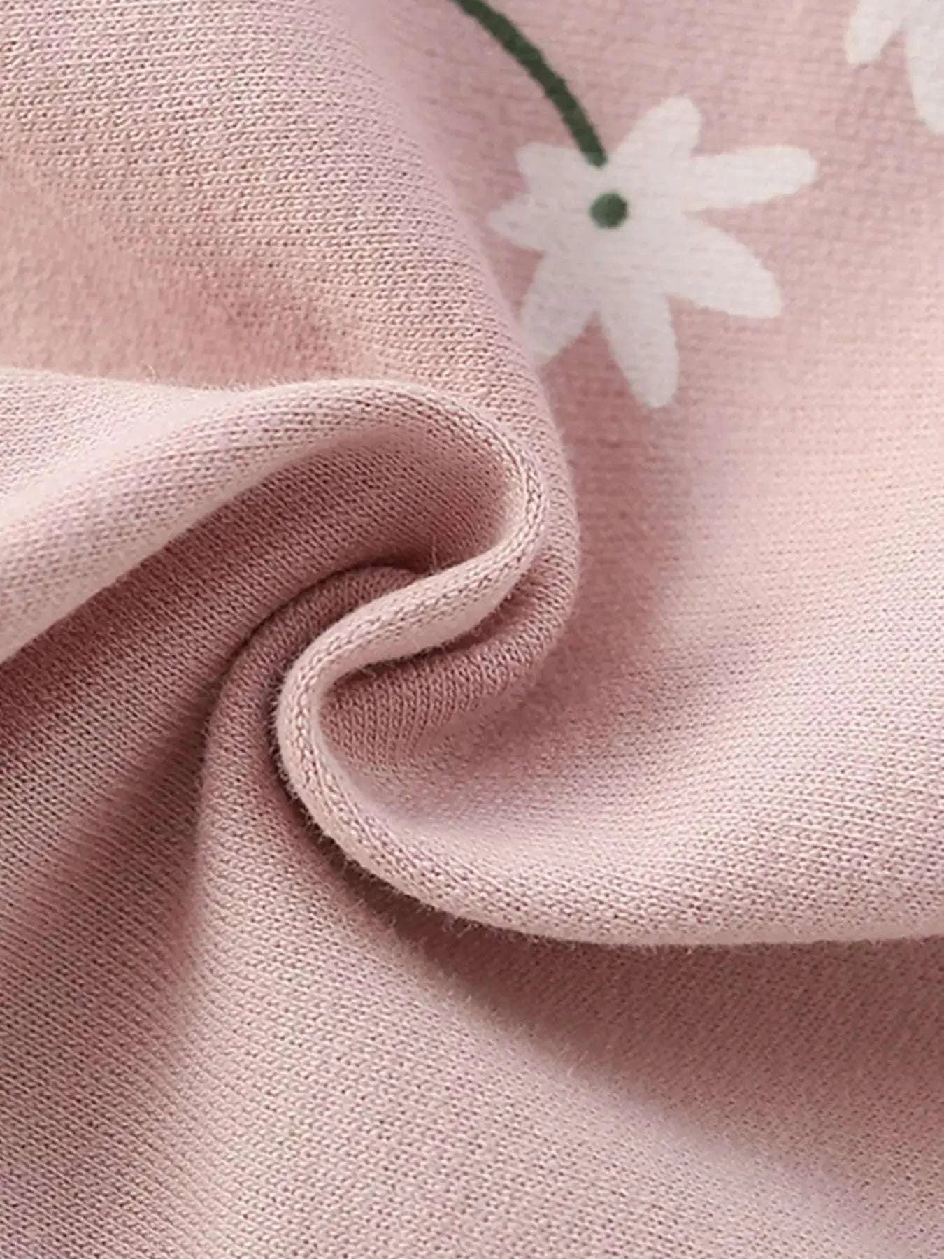 Blush pink knit fabric close-up with soft texture and curved seam