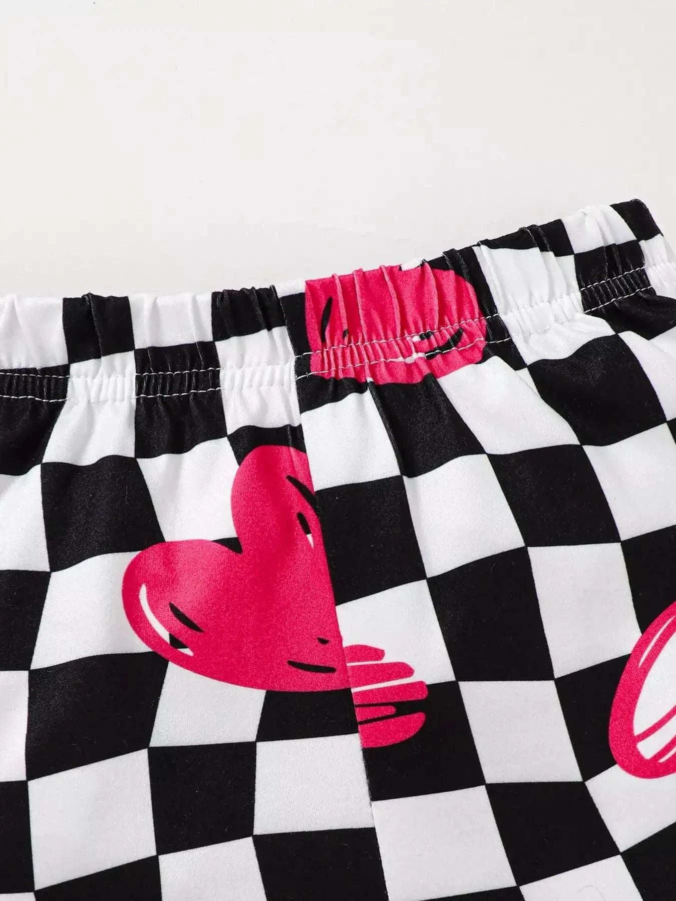 Kids checkerboard shorts with pink hearts and elastic waistband