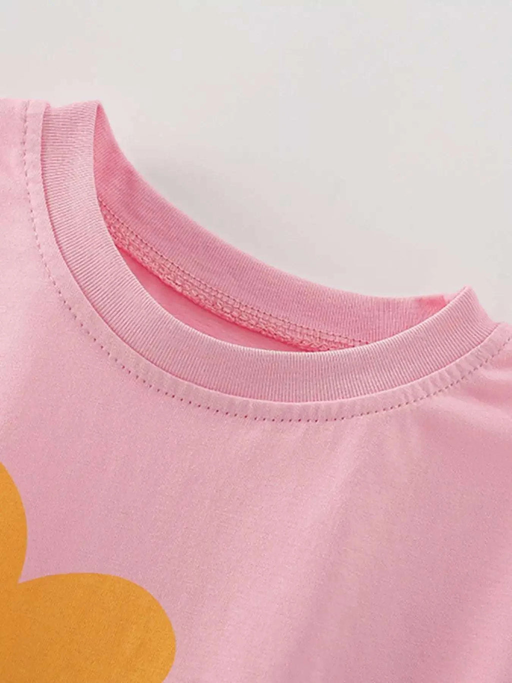 Girls pink crewneck tee with ribbed collar and stitched neckline
