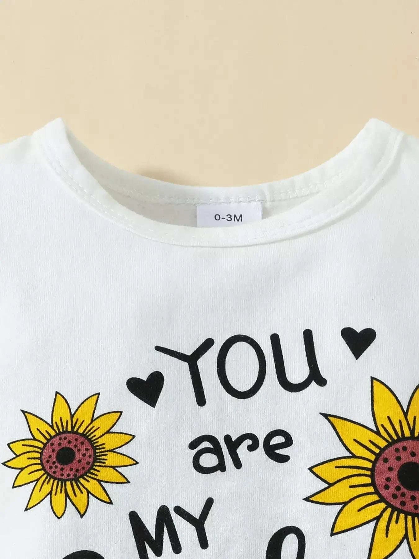 Off-white ruffled bodysuit with crew neck and 'You are my Sunshine' lettering