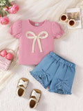 Pink short-sleeve ruffle top with white bowknot front and blue matching shorts set